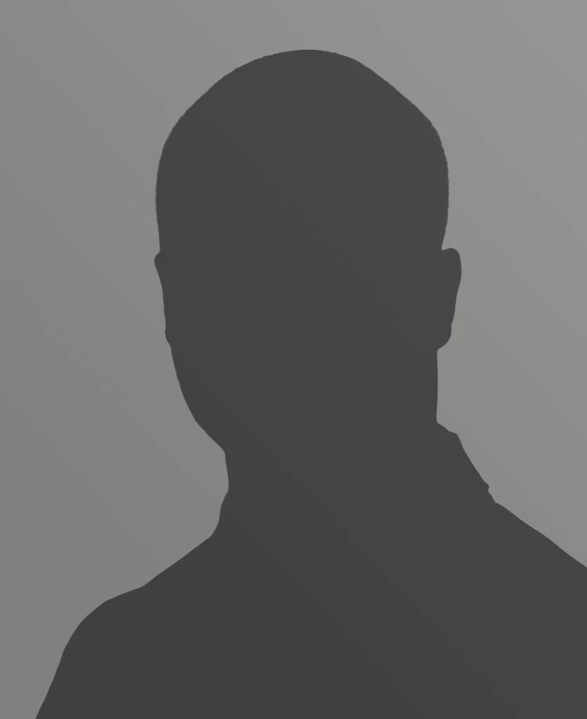 Silhouette of a person's head and shoulders against a gray background.