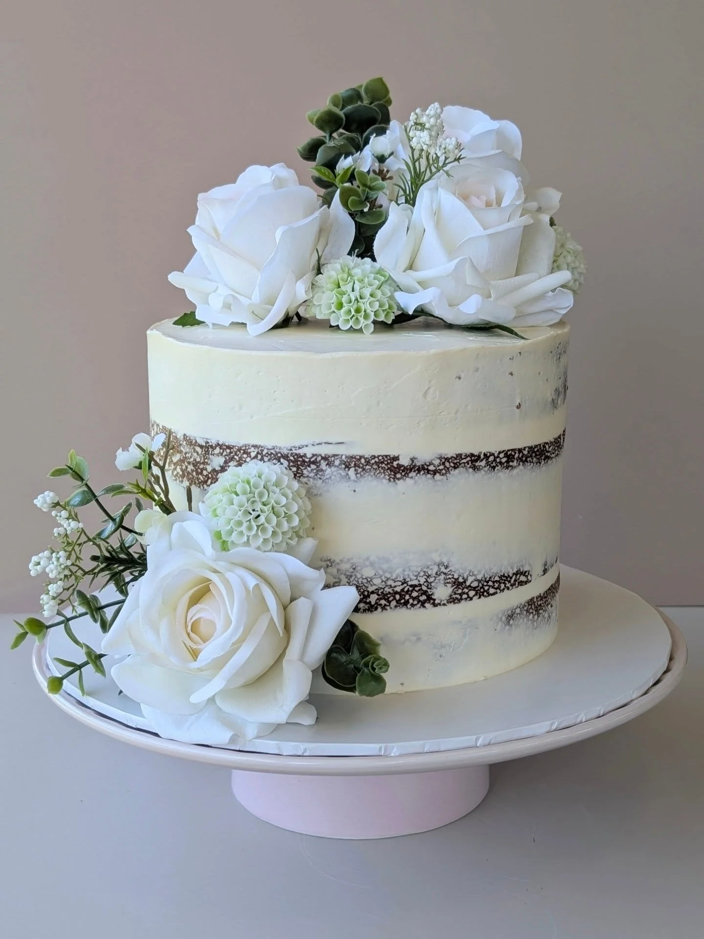 A wedding cake heading out for a local celebration 🤍

Lemon &amp; blueberry (one of your favourites), layered with lemon curd and finished with Swiss meringue buttercream.

Finished with our little signature &mdash; a white chocolate wax seal ✨