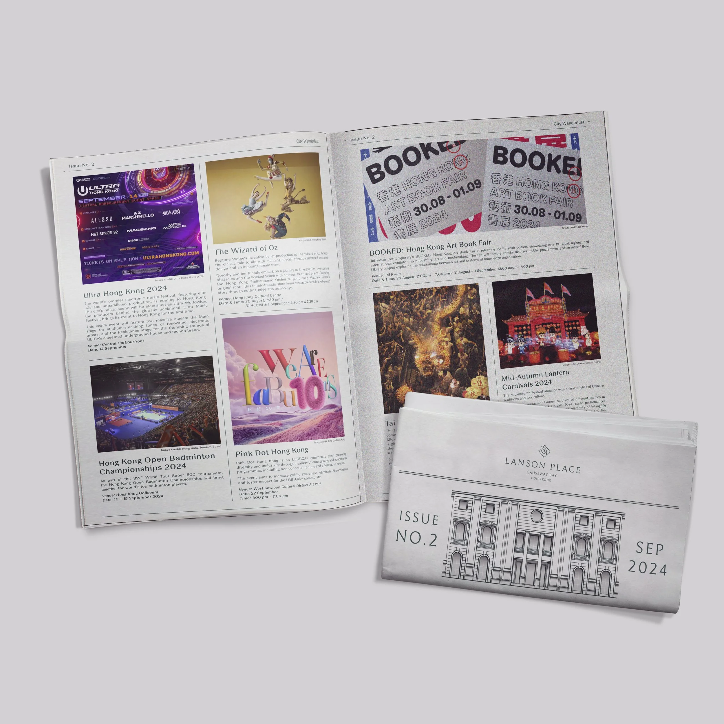 A newspaper open to a page featuring various events and festivals, and a folded magazine or brochure labeled 'Lanson Place Issue No. 2, September 2024' with a drawing of a building.