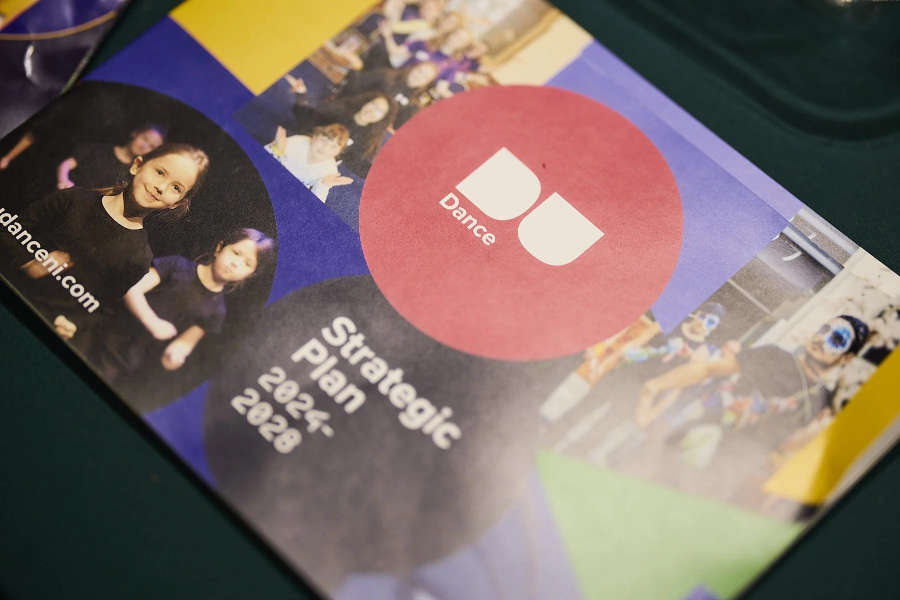 Printed flyer for a dance studio's strategic plan from 2024 to 2028, featuring photos of dancers, colorful circles with text, including a red circle with 