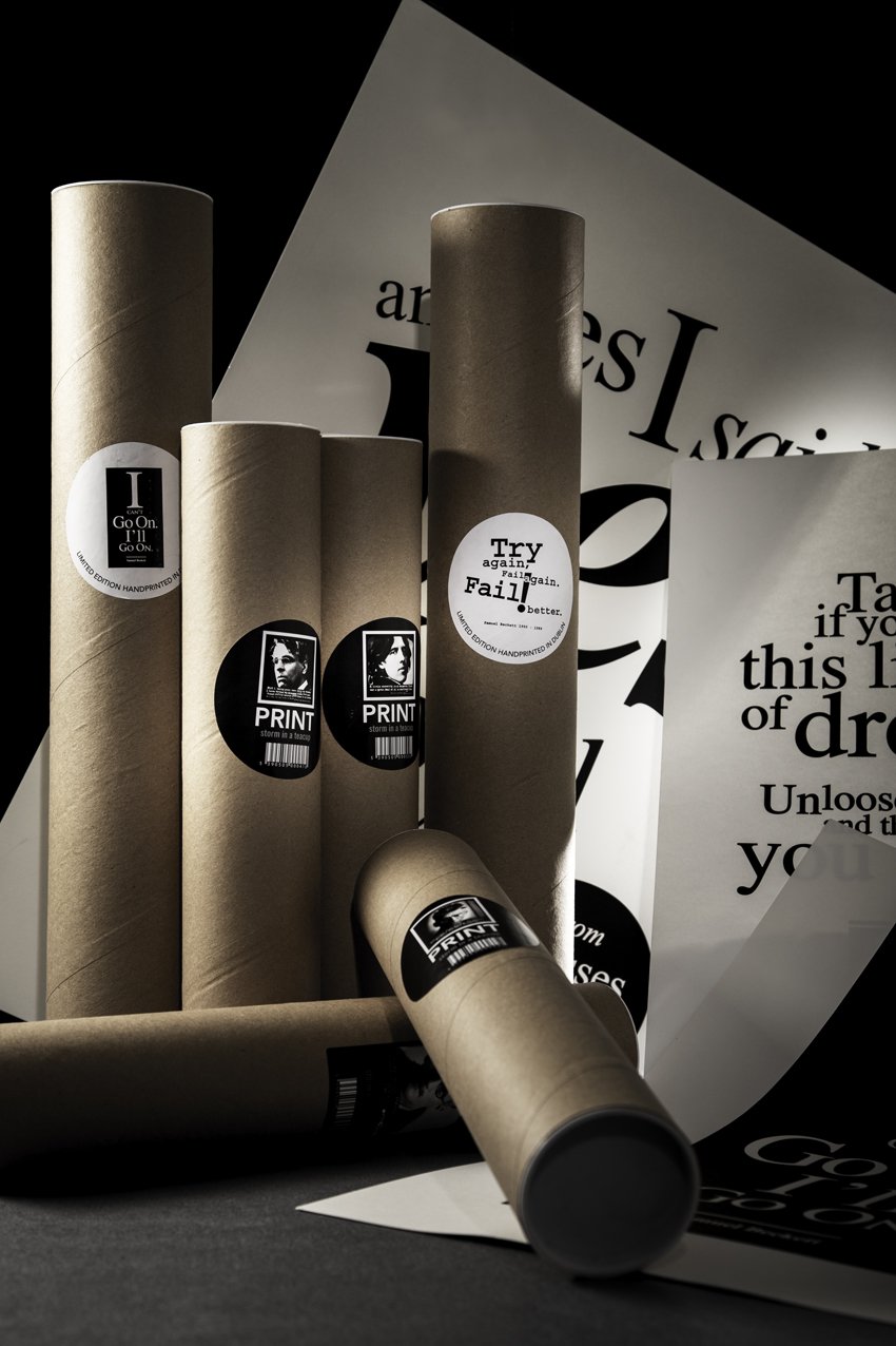  High end advertising profession product photo taken in studio of multiple cardboard tubes with black and white labels and printed paper with motivational quotes.