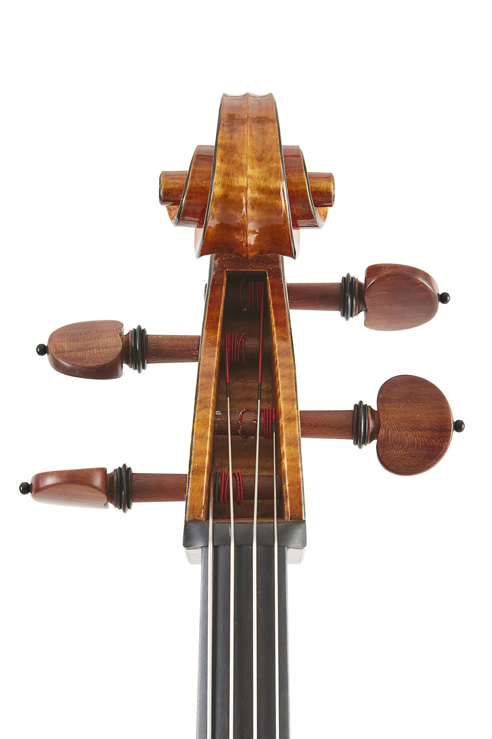 Advertising profession product photo taken in studio of a close-up of a violin's scroll, tuning pegs, and part of the fingerboard against a white background.