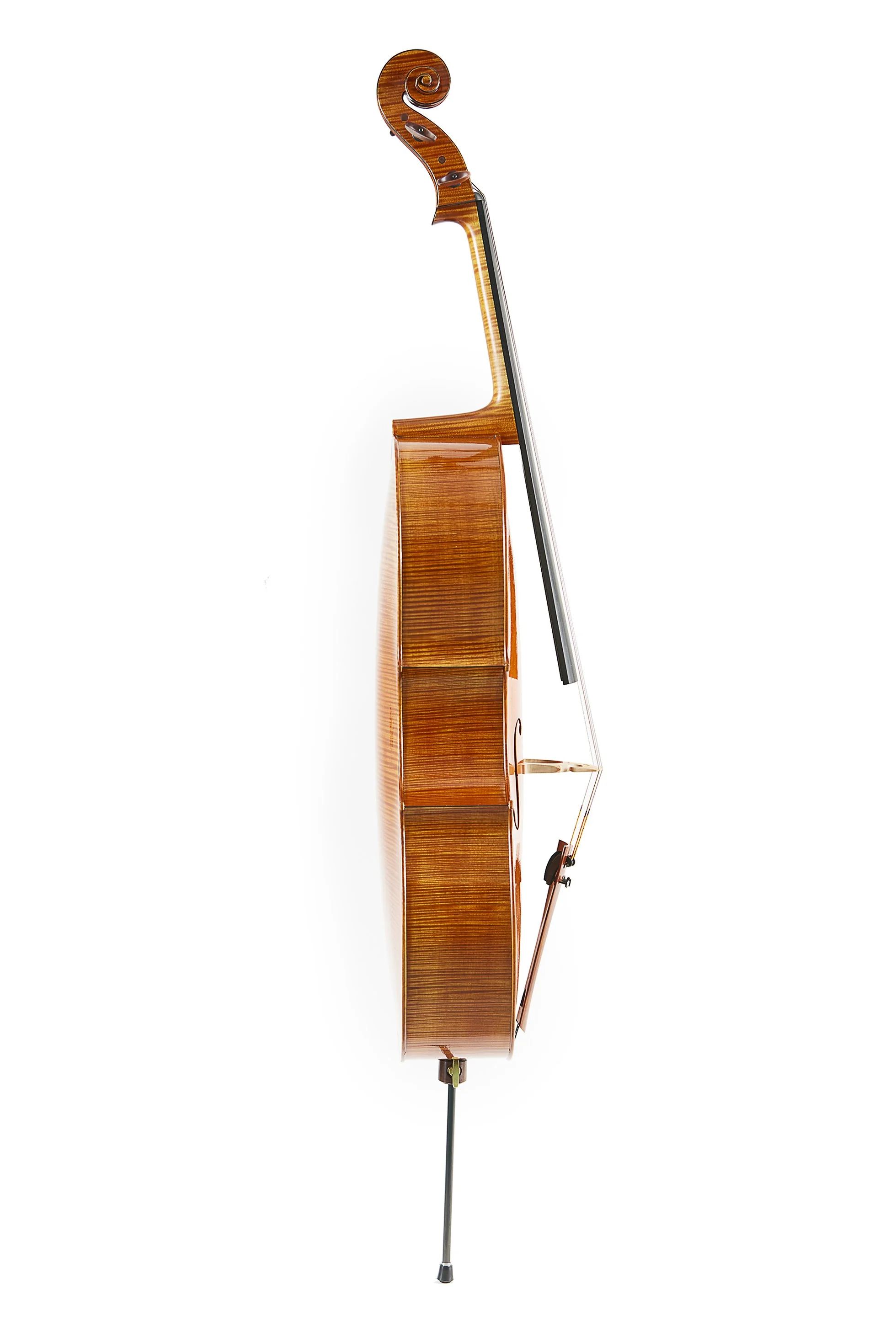 Advertising profession product photo taken in studio of a side view of a polished wooden upright piano with a black and white keyboard, against a plain white background.