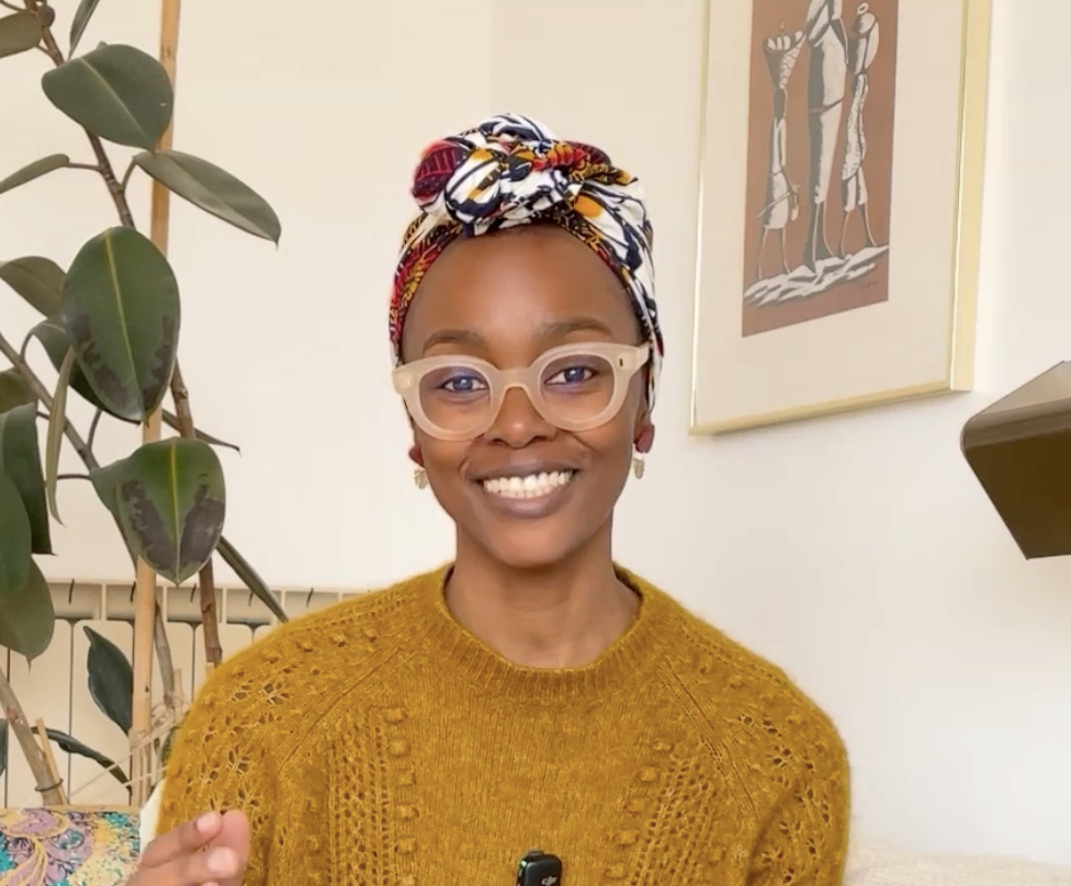 Fertility coach smiling on couch discussing fertile window