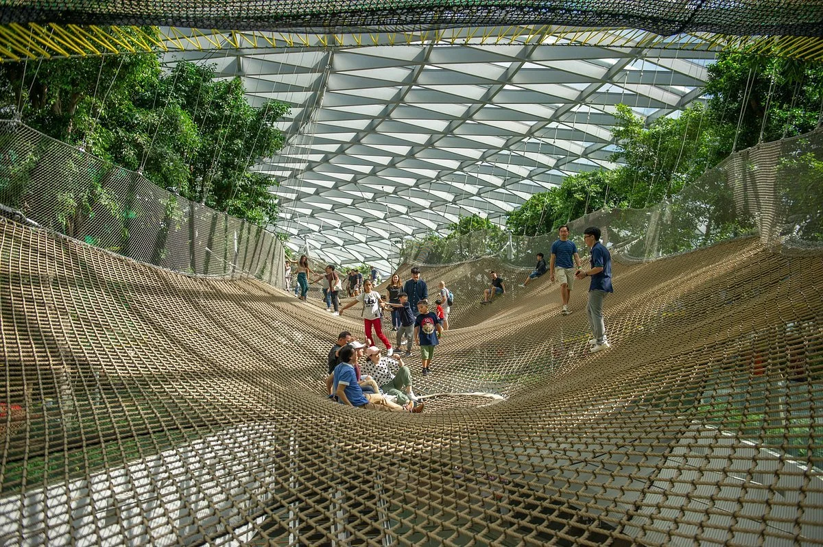 people bouncing on the bouncing net at canopy park inside jewel changi airport singapore