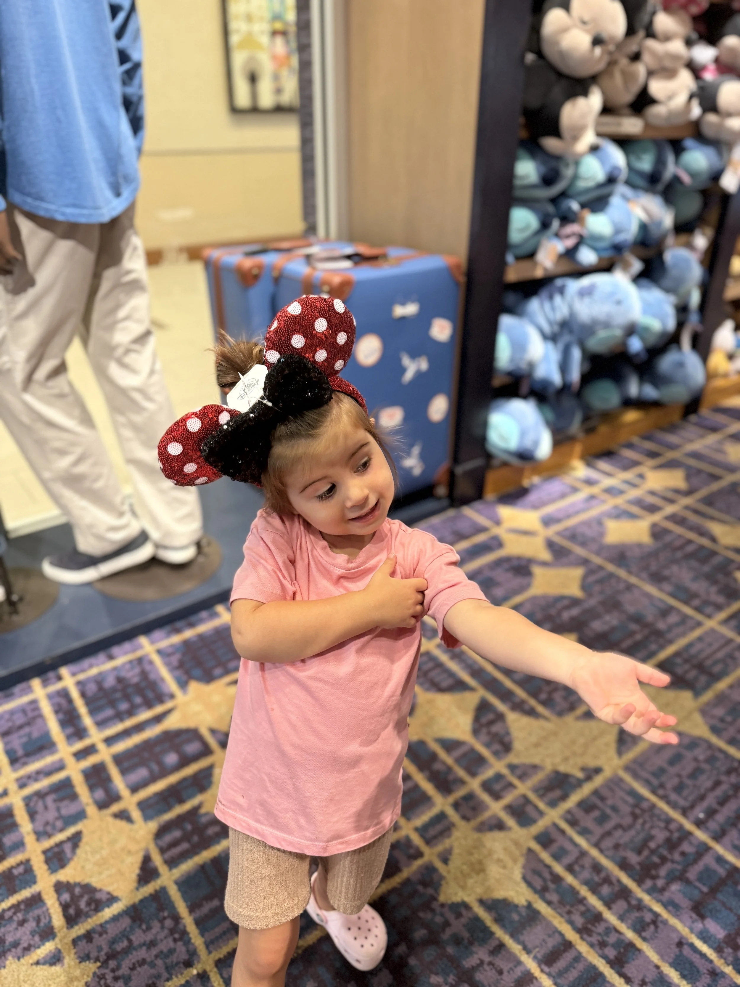 Athena-trying-on-ears-in-the-fantasia-shop-disneyland-hotel.JPEG