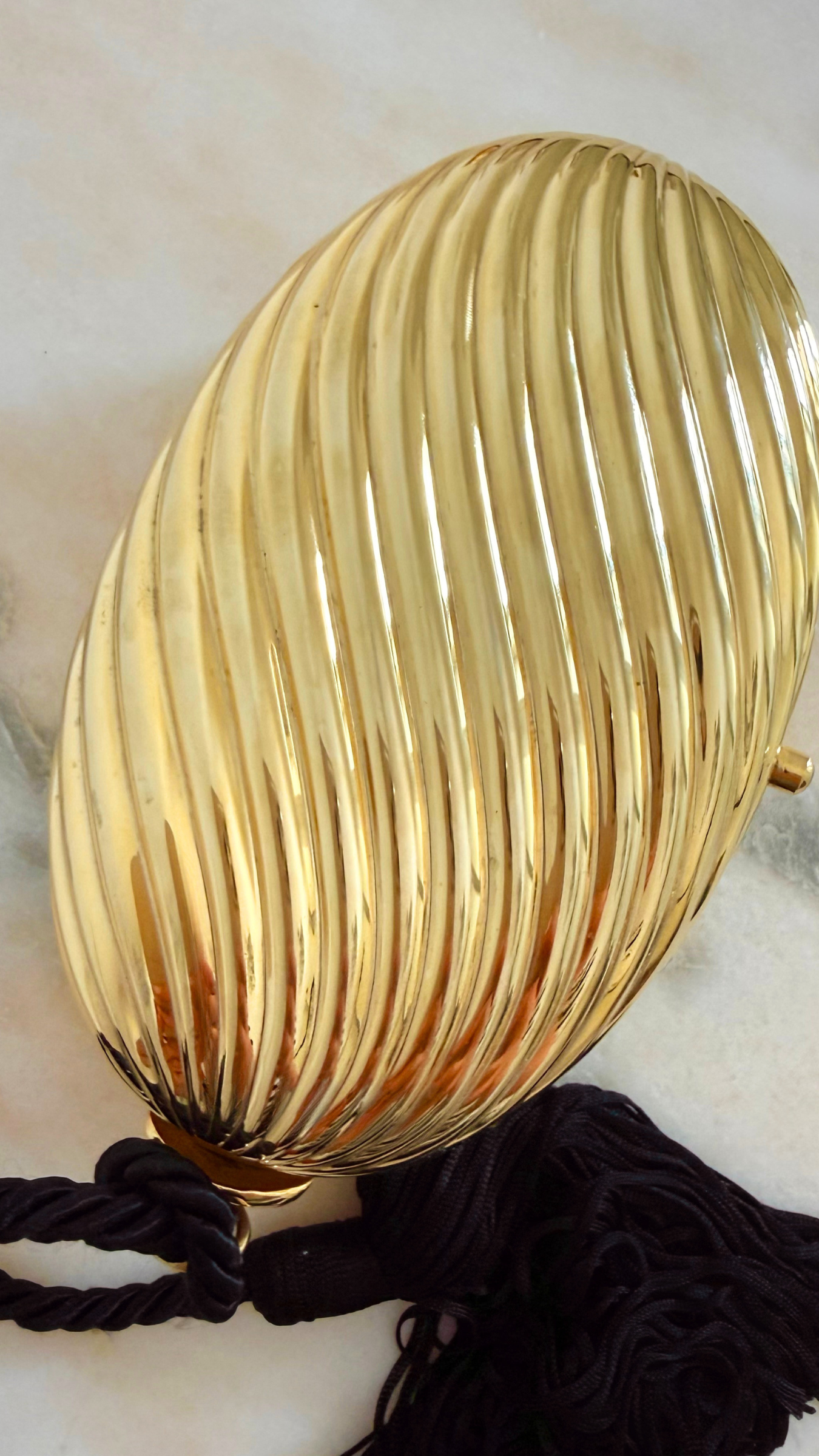 GOLD RIBBED EGG MINAUDIÈRE WITH TWO TASSELS 18.png