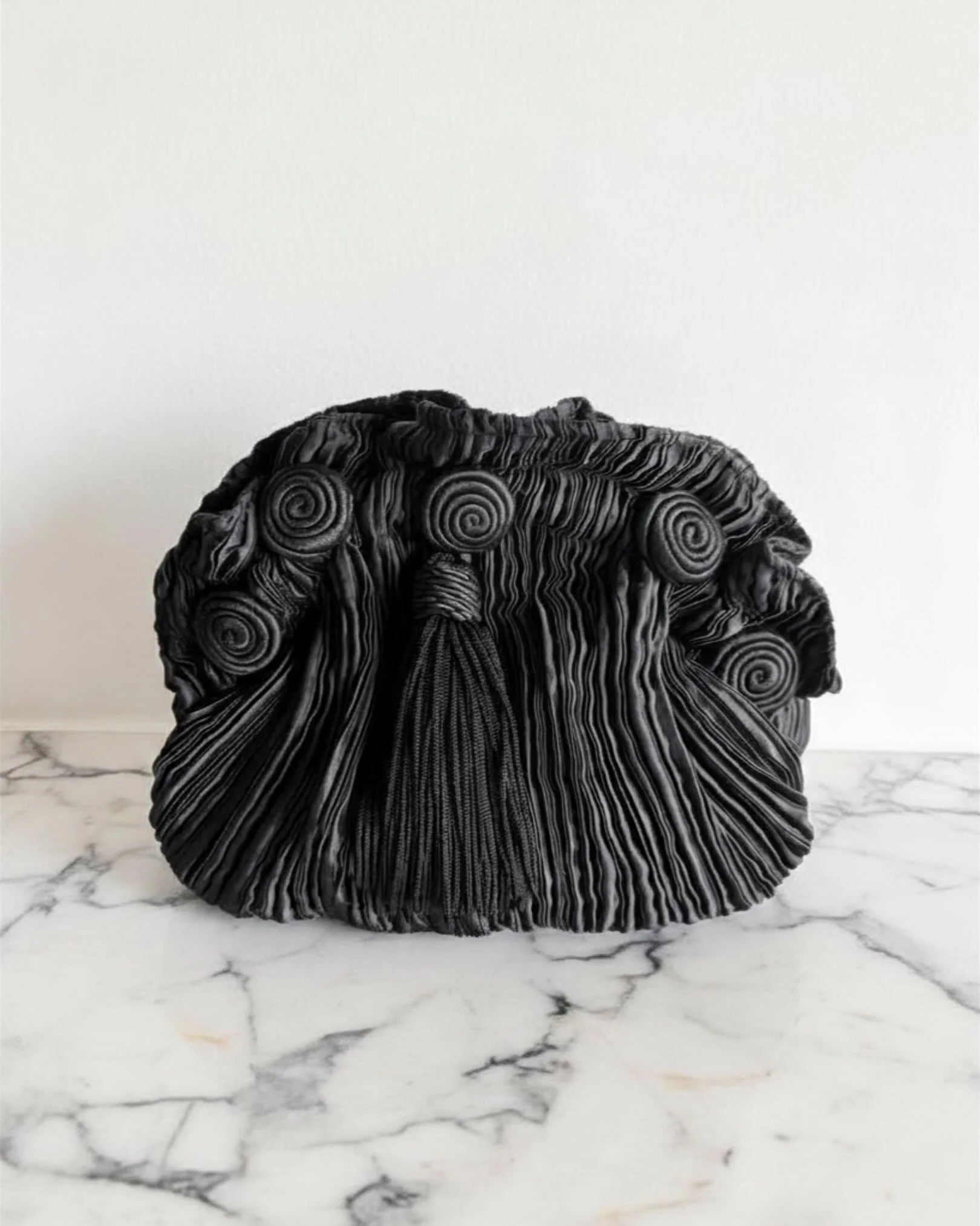 Scheilan Firenze Pliss&eacute; bag with tassel and rosettes available at www.thechicaunt.com 

Pleats have deep roots in the history of women&rsquo;s clothing, think of the peplos worn by women in ancient Greece. Pleats are also reminiscent of classi