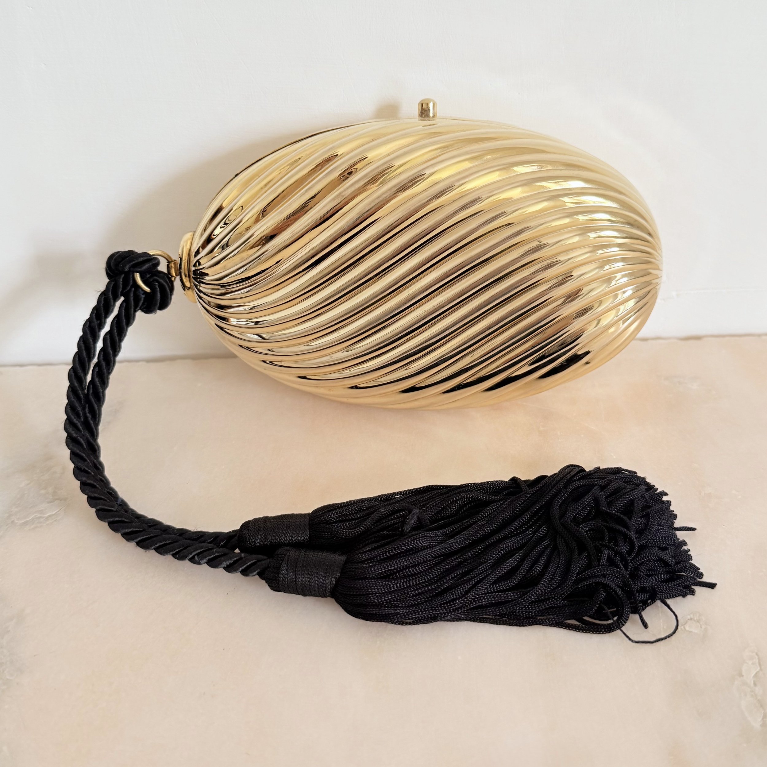 GOLD RIBBED EGG MINAUDIÈRE WITH TWO TASSELS 3.jpeg