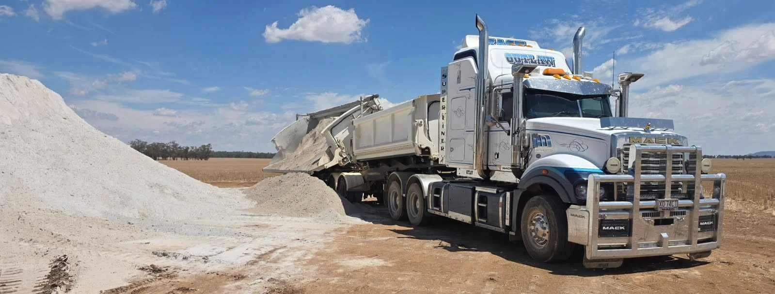 Truck fleet transporting bulk materials for construction projects, supporting site supply and logistics