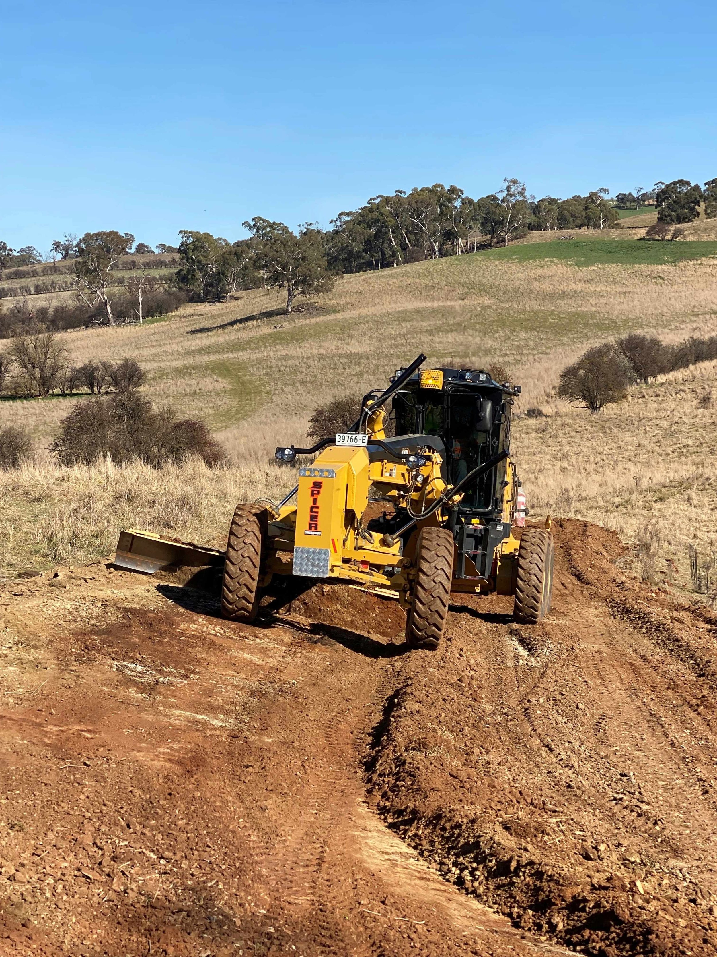 Civil works constructing access roads for farm infrastructure under grant-supported project.