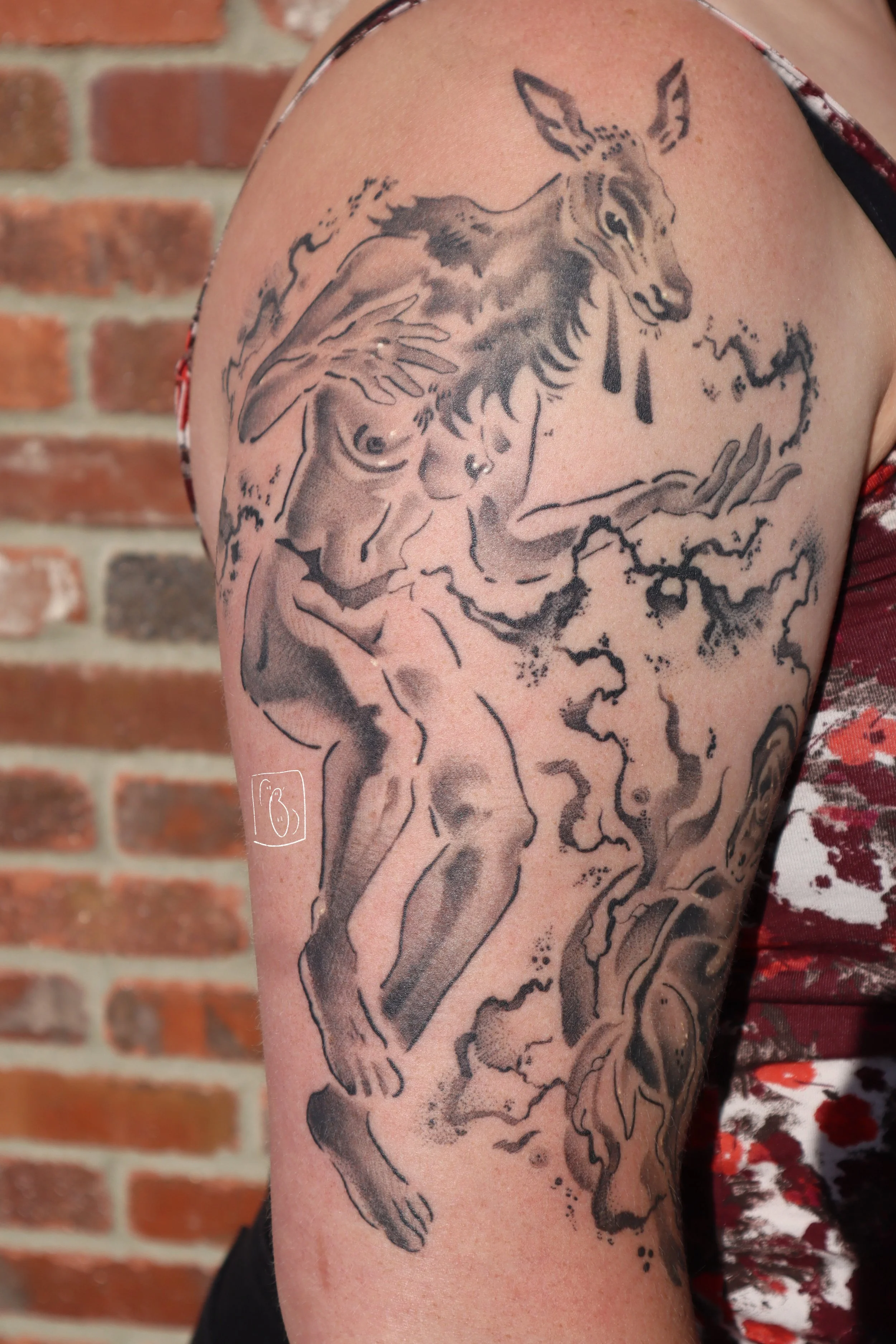 tattoo interpretation of the elk headed woman from stephen graham jones' book. her head is a doe elk, tears dripping from her face, and her body is humanoid. from a rough incision in her stomach flows black ichor. on the client's upper arm
