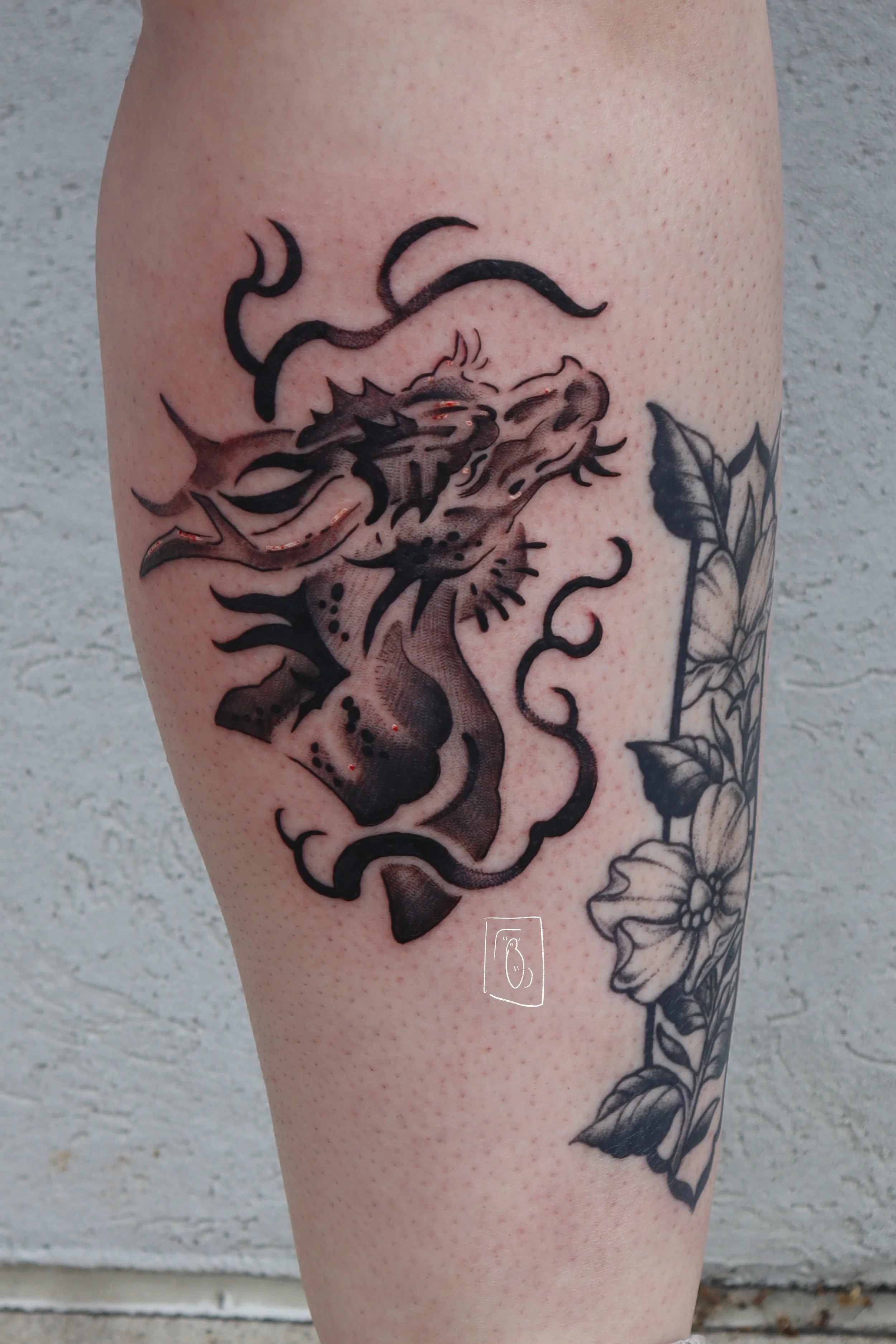 a bust of a dragon with spiky, elegant horns and spines around the brow. there is black, abstract fire around the form