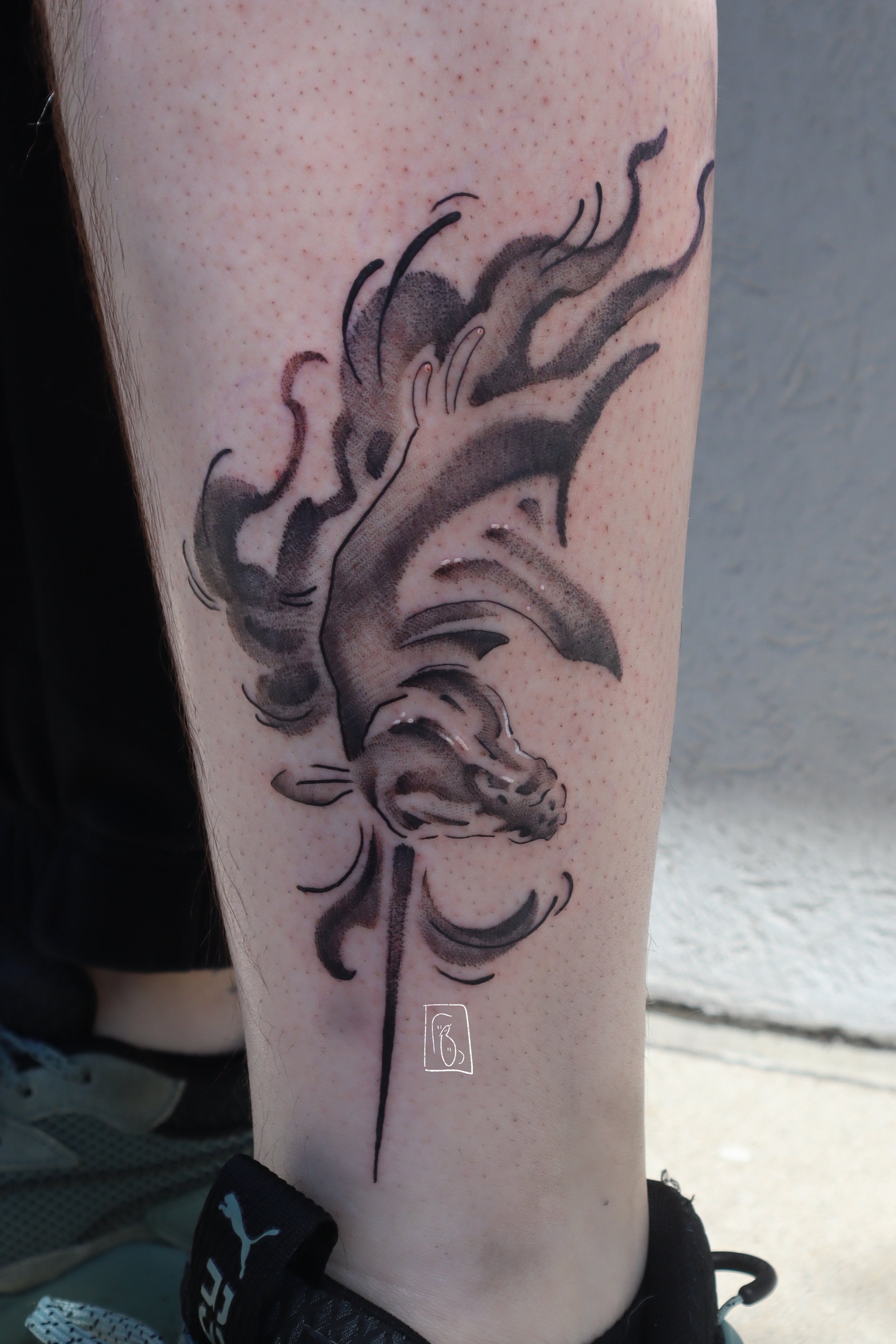 a tattoo unicorn bust at a downward angle the client’s angle, the horn points down and the hair is flowing