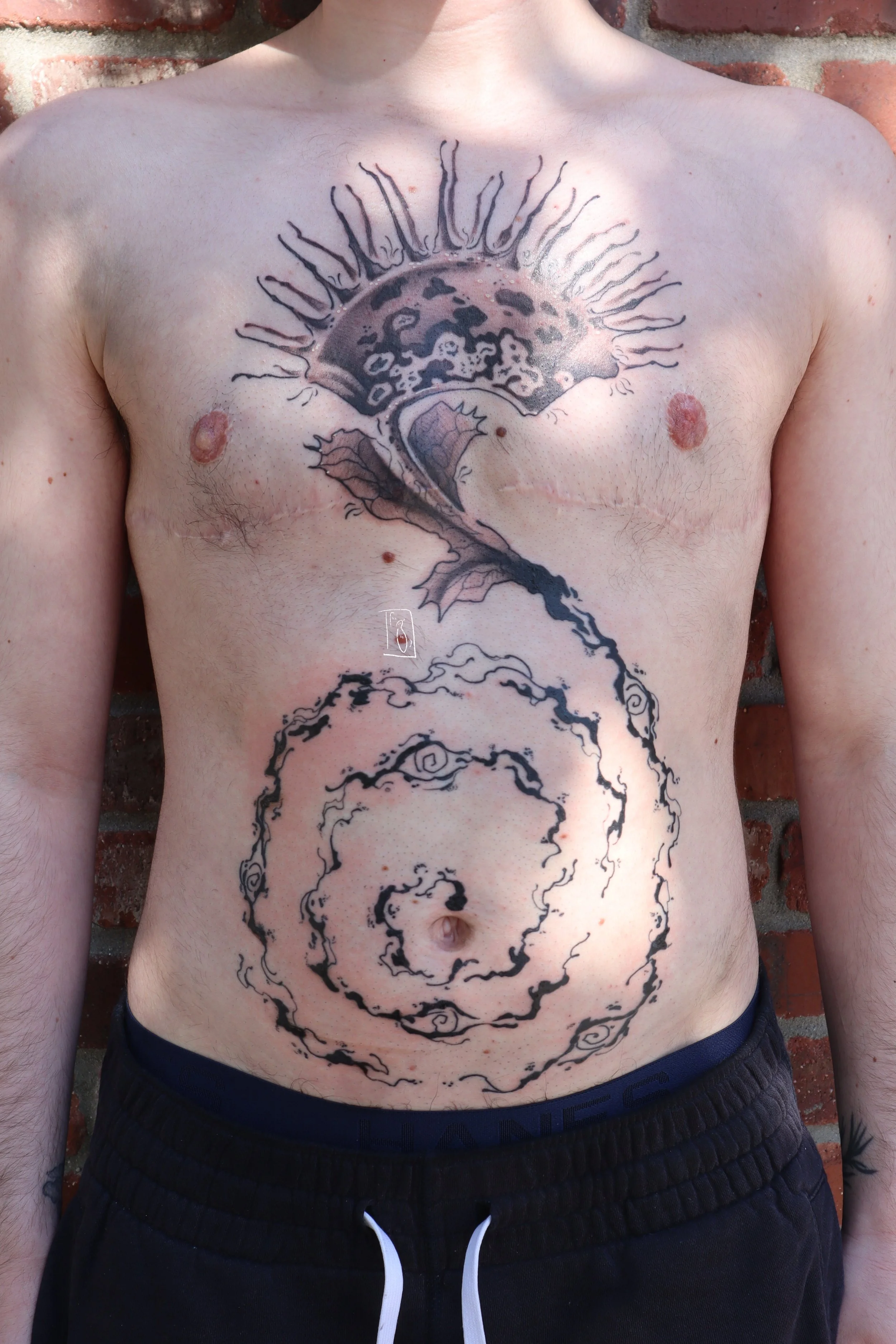 a full torso project. there is a venus fly trap that spans across the client’s upper chest. coming down and in towards the navel is a black venom swirl with eyes along the form, and it closes in on the navel,
