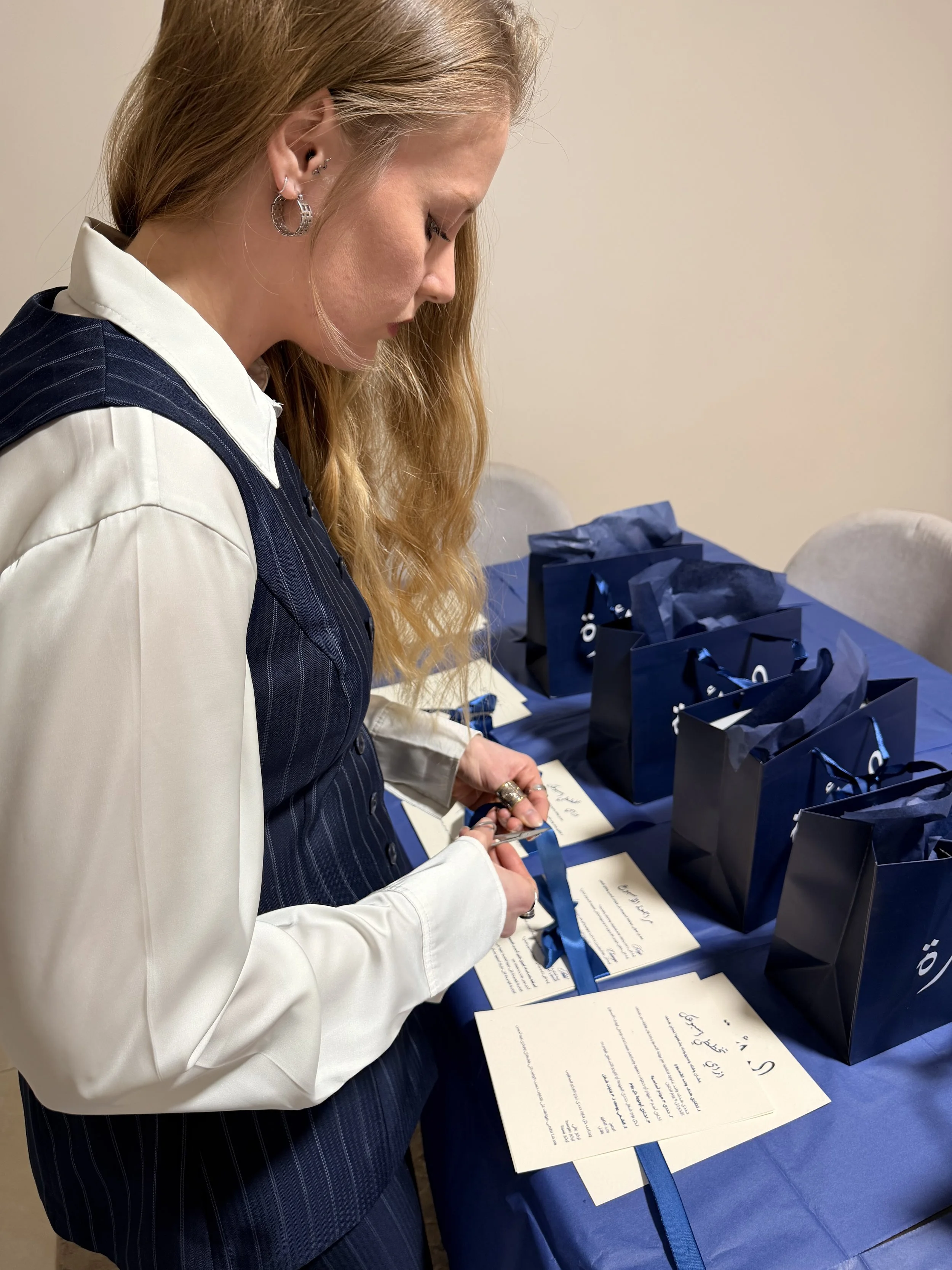 Founder of EASTXWEST MEDIA preparing for an event launch and sorting out the event swag bags.