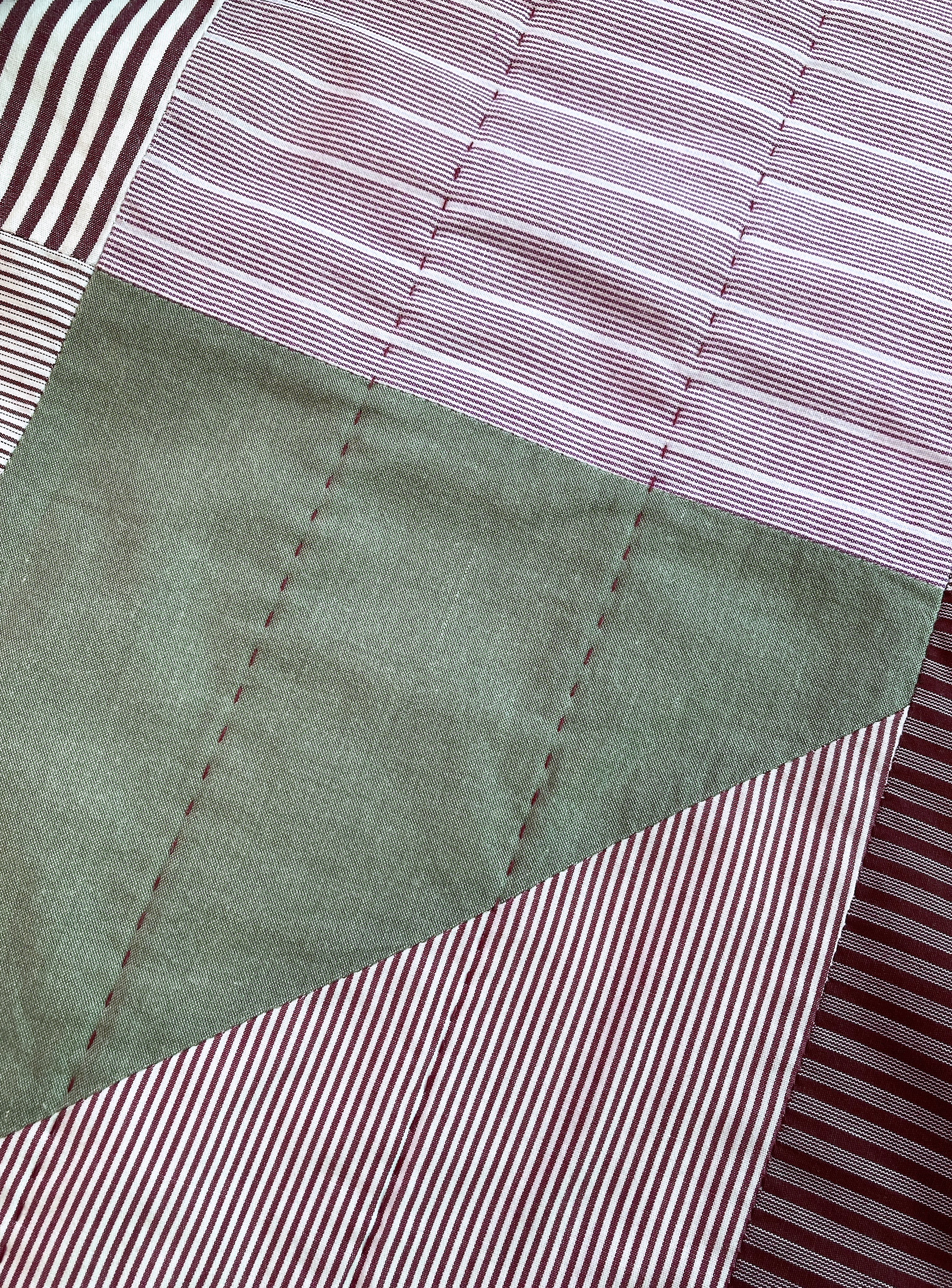 A detail of Sequoia, a hand stitched Blunt Objects patchwork quilt by designer maker Carolyn Thompson