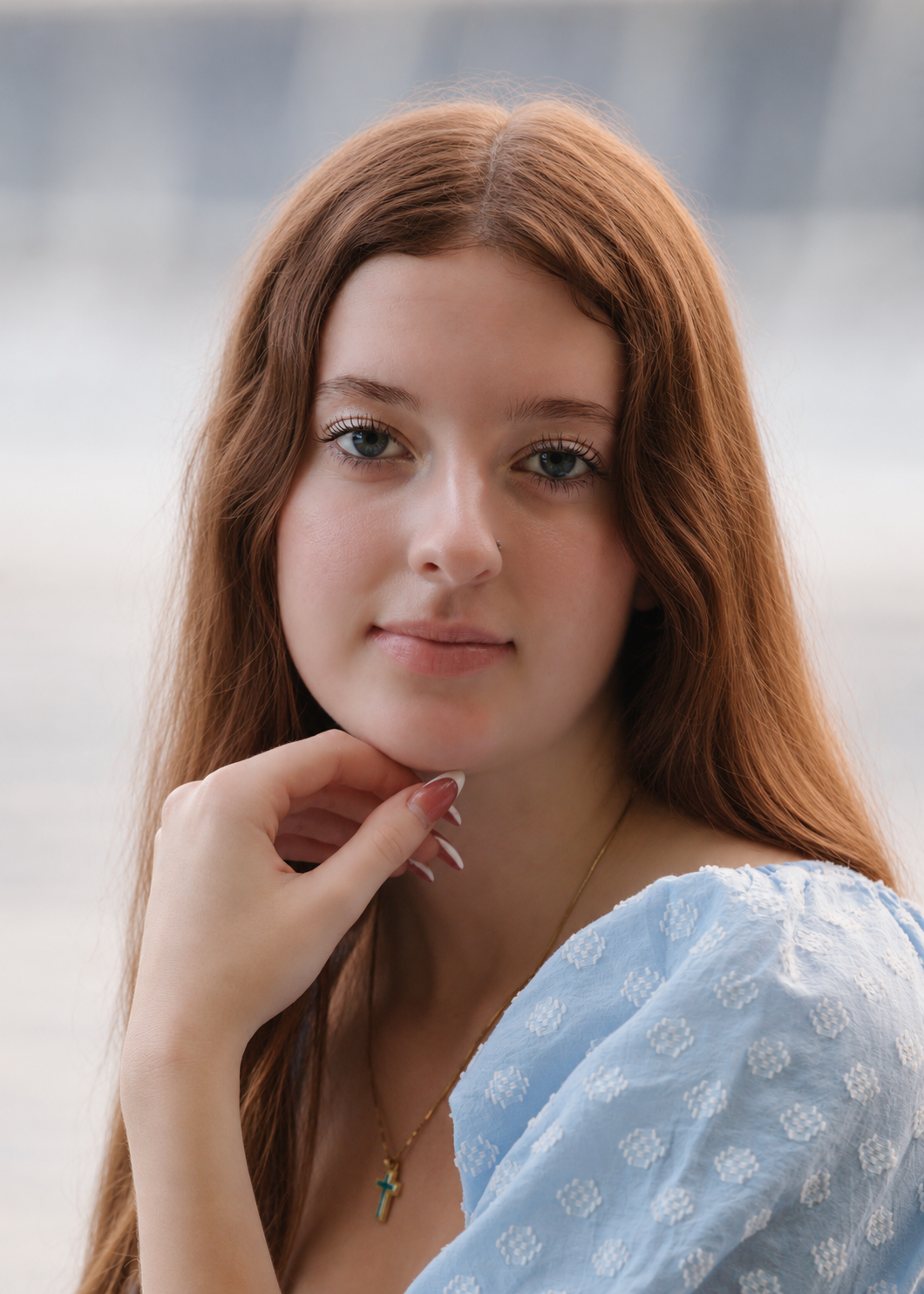 Auburn Portrait with Cross Necklace.png