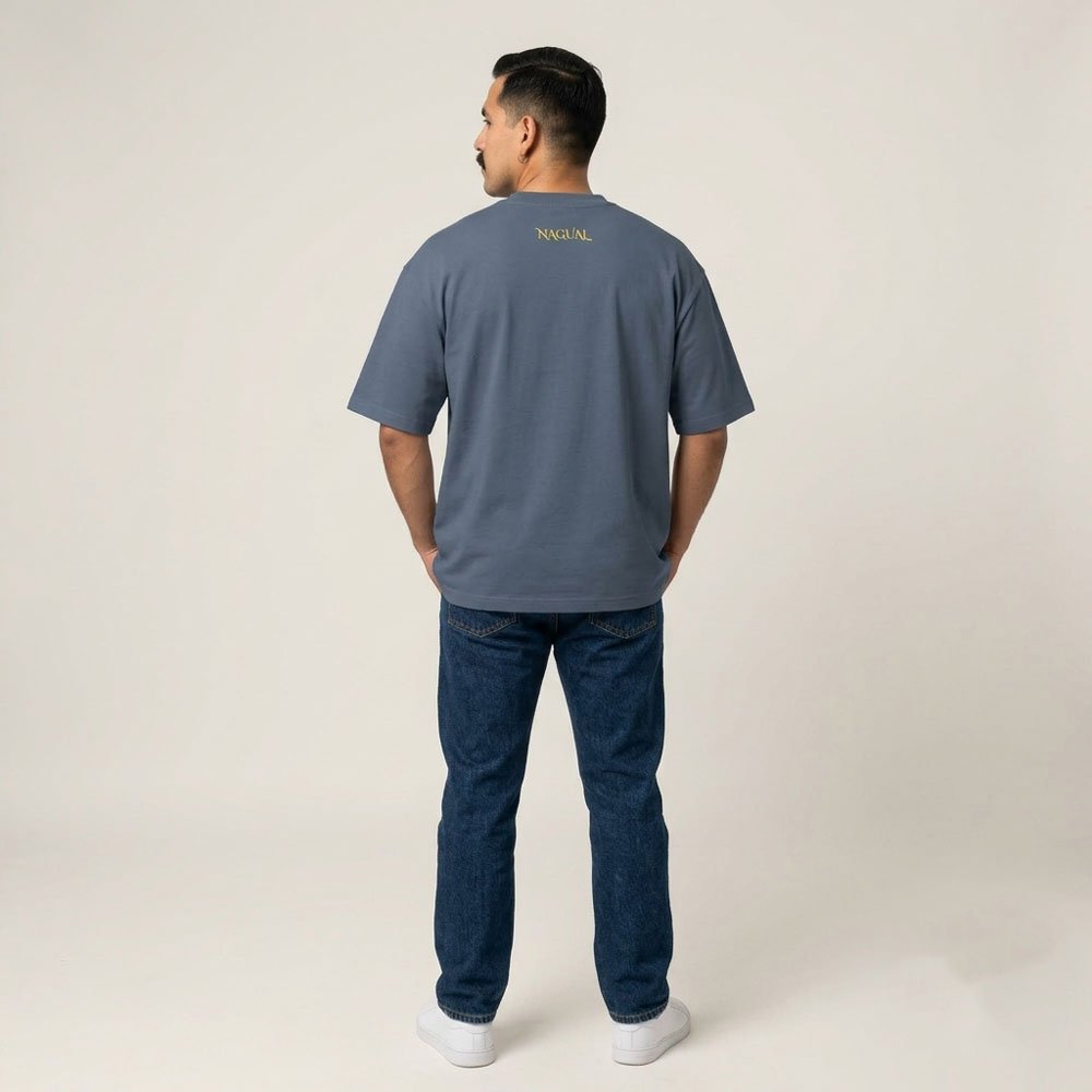 Back view of the Wrestling Is Art oversized tee showing the wordmark, worn with black pants
