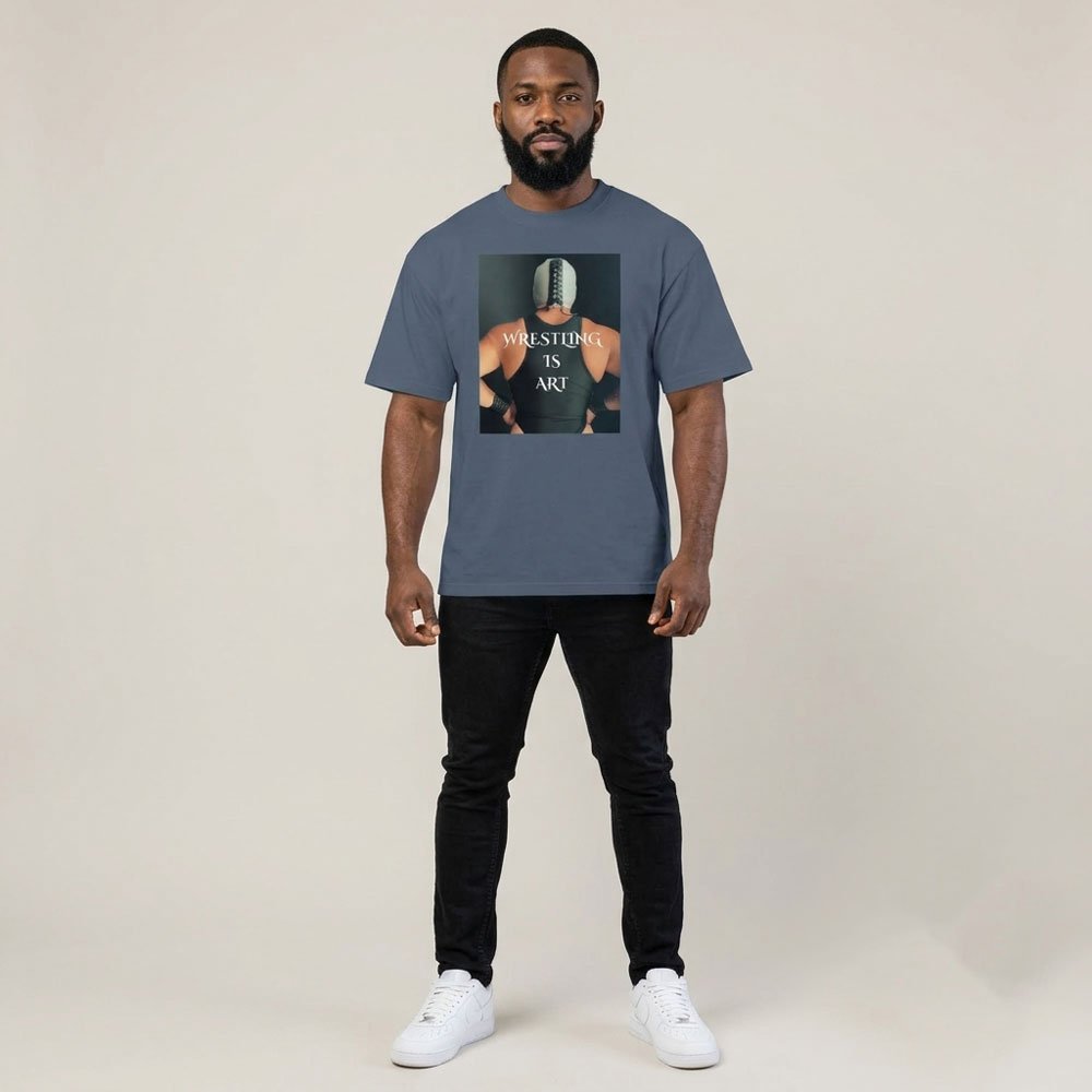 Front view of the Wrestling Is Art oversized tee in faded indigo, worn with black pants