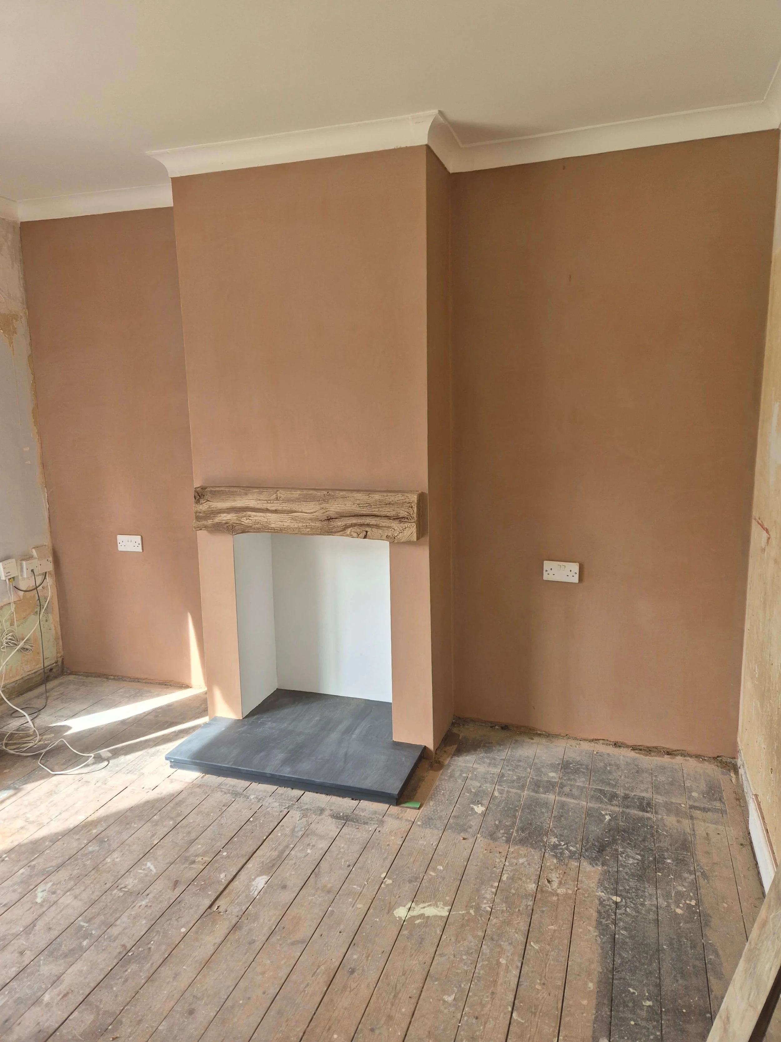 Reskimmed chimney breast, surrounding walls, and repaired cornice
