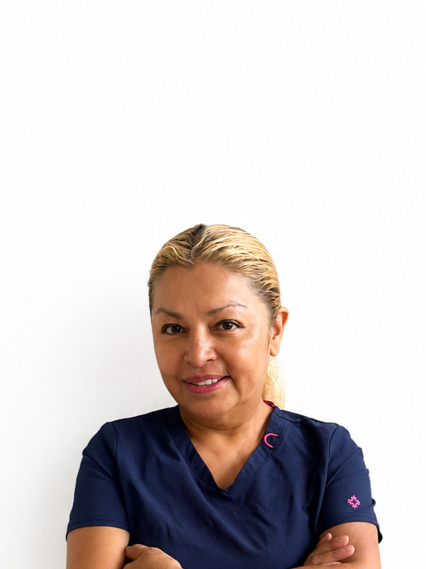 A woman with blonde hair pulled back, wearing navy scrubs, standing against a plain white background.