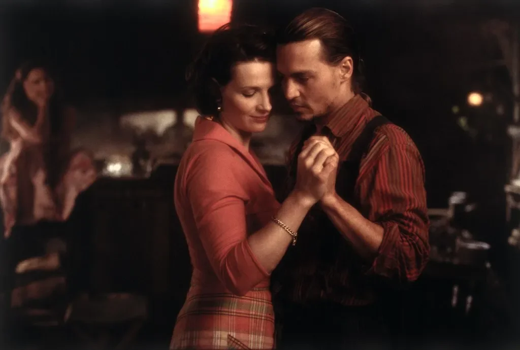 A warm, intimate dancing scene with Roux (Johnny Depp) and Vianne (Juliette Binoche) from the movie Chocolat with warm lighting and intimate atmosphere
