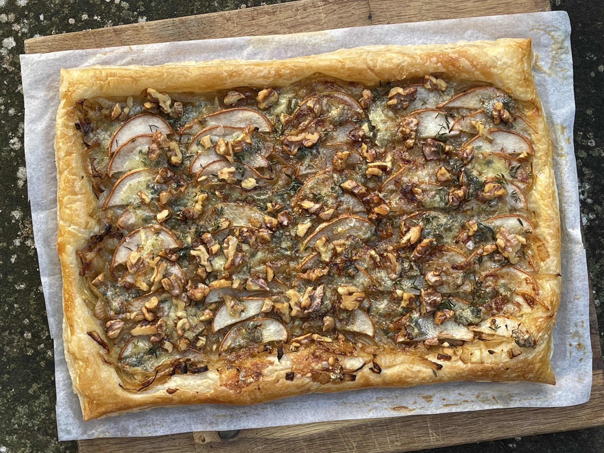 Pear caramelized onion walnut and Stilton puff pastry tart recipe from Story Feast immersive dining event at St. John's Abbey in Minnesota — farm-to-table seasonal cooking