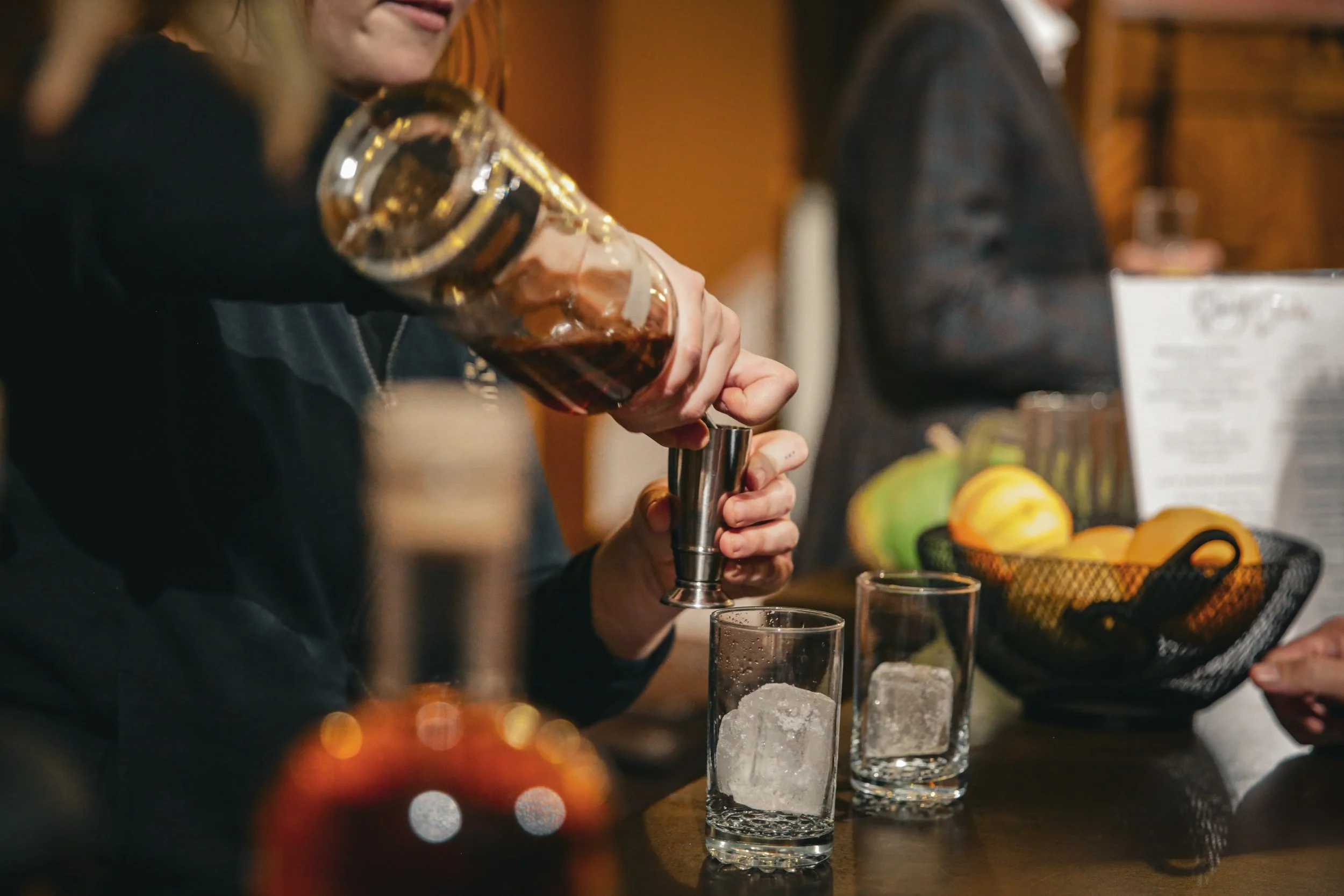 Brother Justus Whiskey founder Phil Steger pouring single malt whiskey for guests during the Story Feast cocktail hour at St. John's Abbey in Minnesota