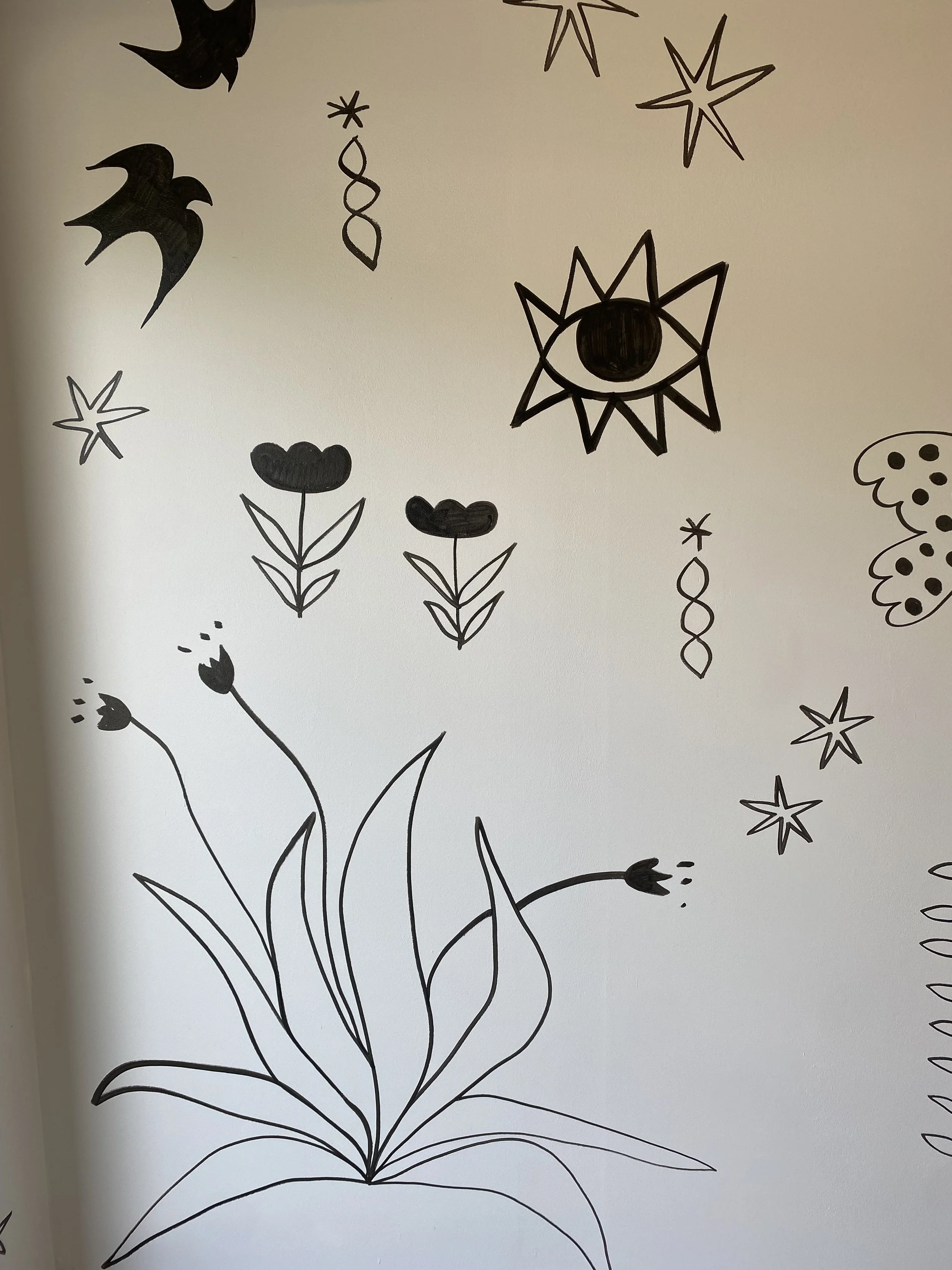 Black line drawings of various abstract plants, flowers, and star-like shapes on a white background.