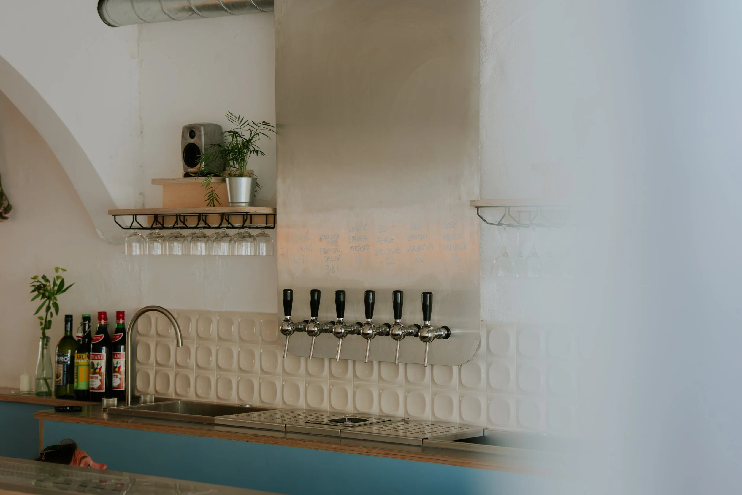 OUTGROWN, wine bar taps and bar. curved tiles, blue plywood, cocktail station.
