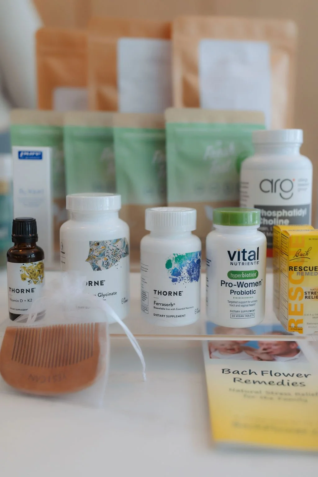 Various dietary supplement bottles, herbal remedies, and informational pamphlets on herbal remedies and Bach flower remedies on a white surface.