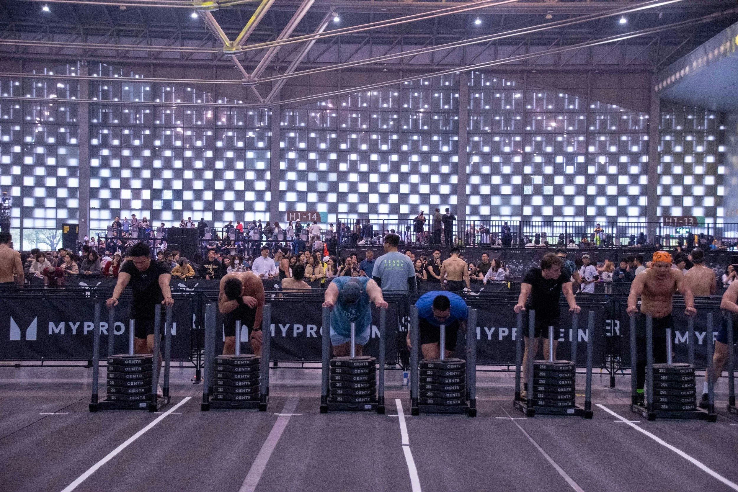 hyrox and crossfit competitors in a weightlifting and hybrid event