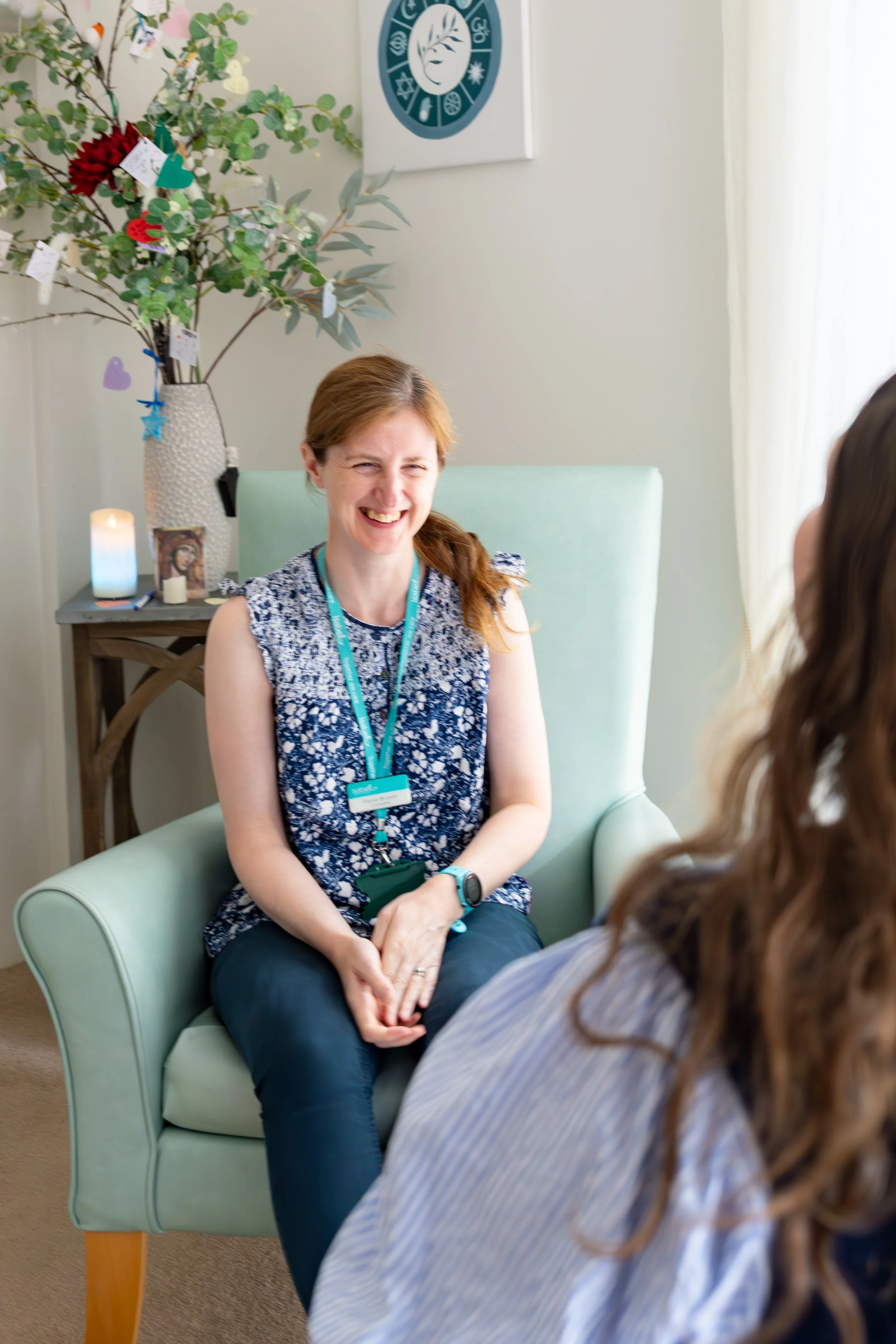 women laughing whilst talking to a customer 