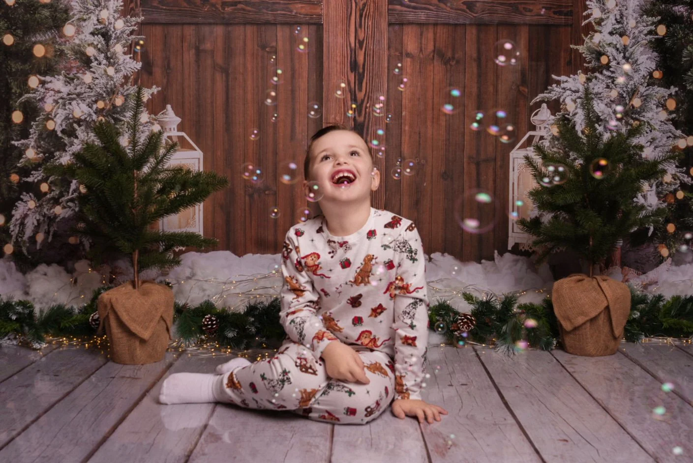 a-little-boy-sitting-on-the-floor-surrounded-by-bubbles-and-christmas