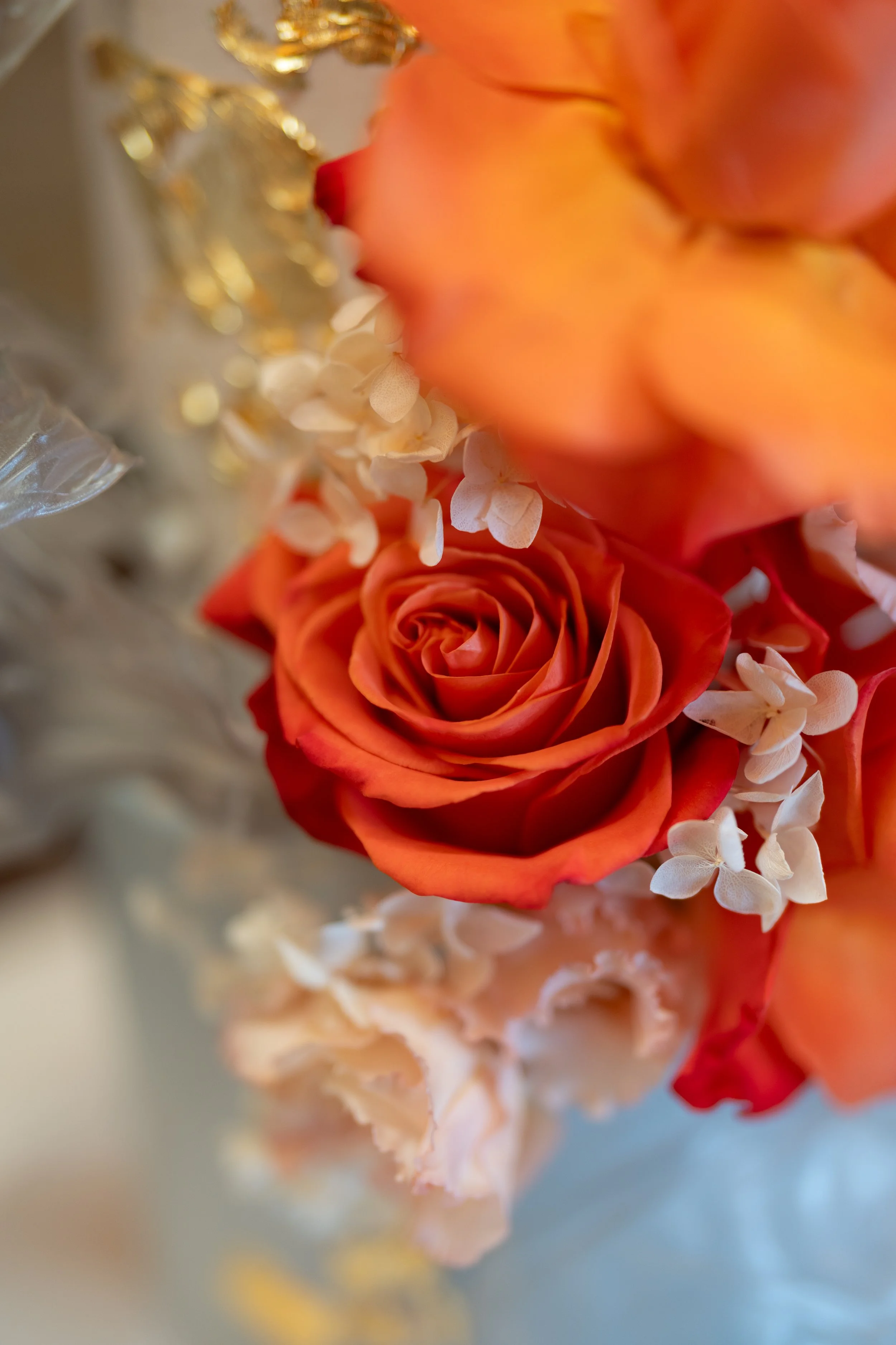 a-vase-filled-with-flowers-and-a-gold-leaf.jpg
