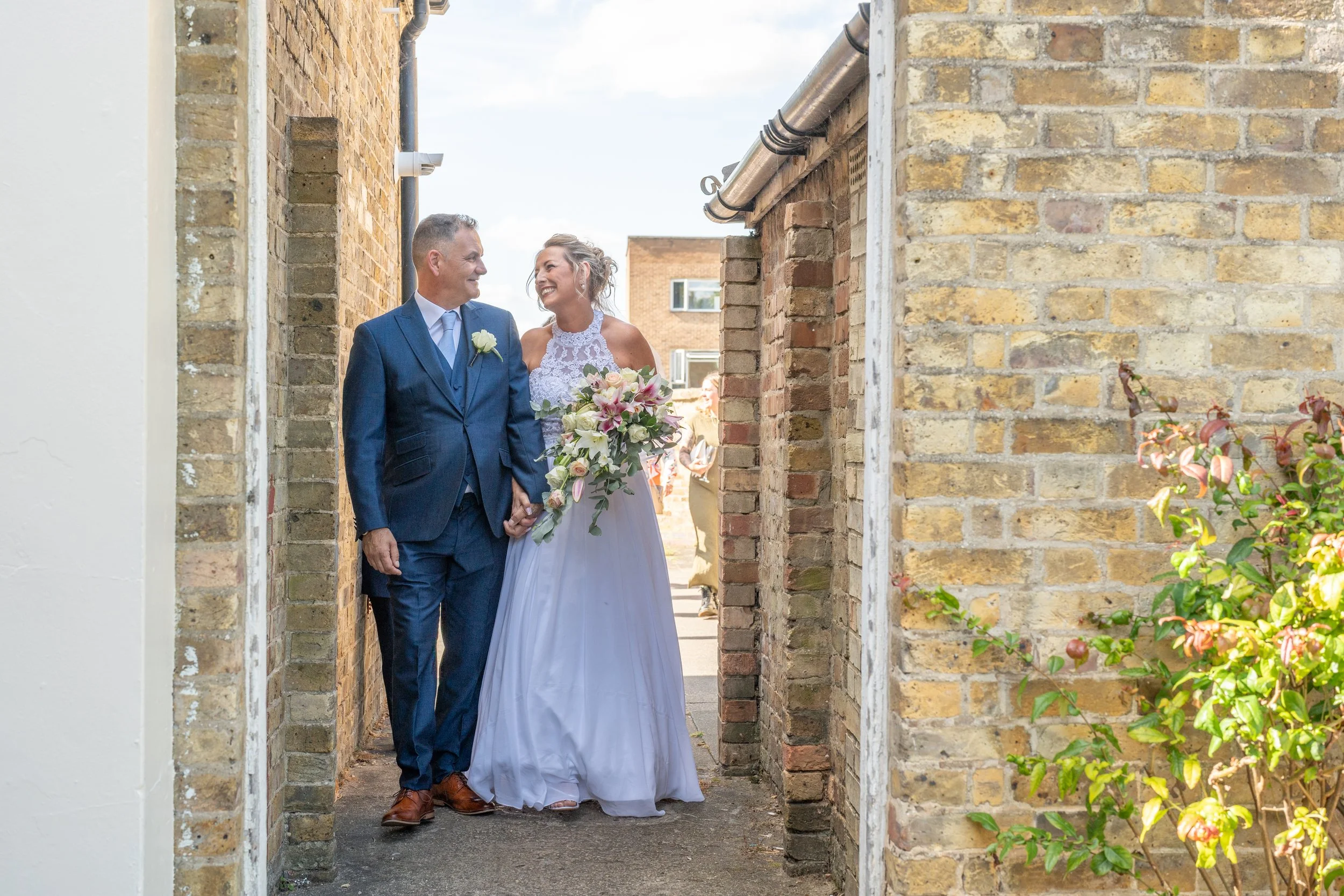 a-bride-and-groom-walking-through-a-doorway.jpg