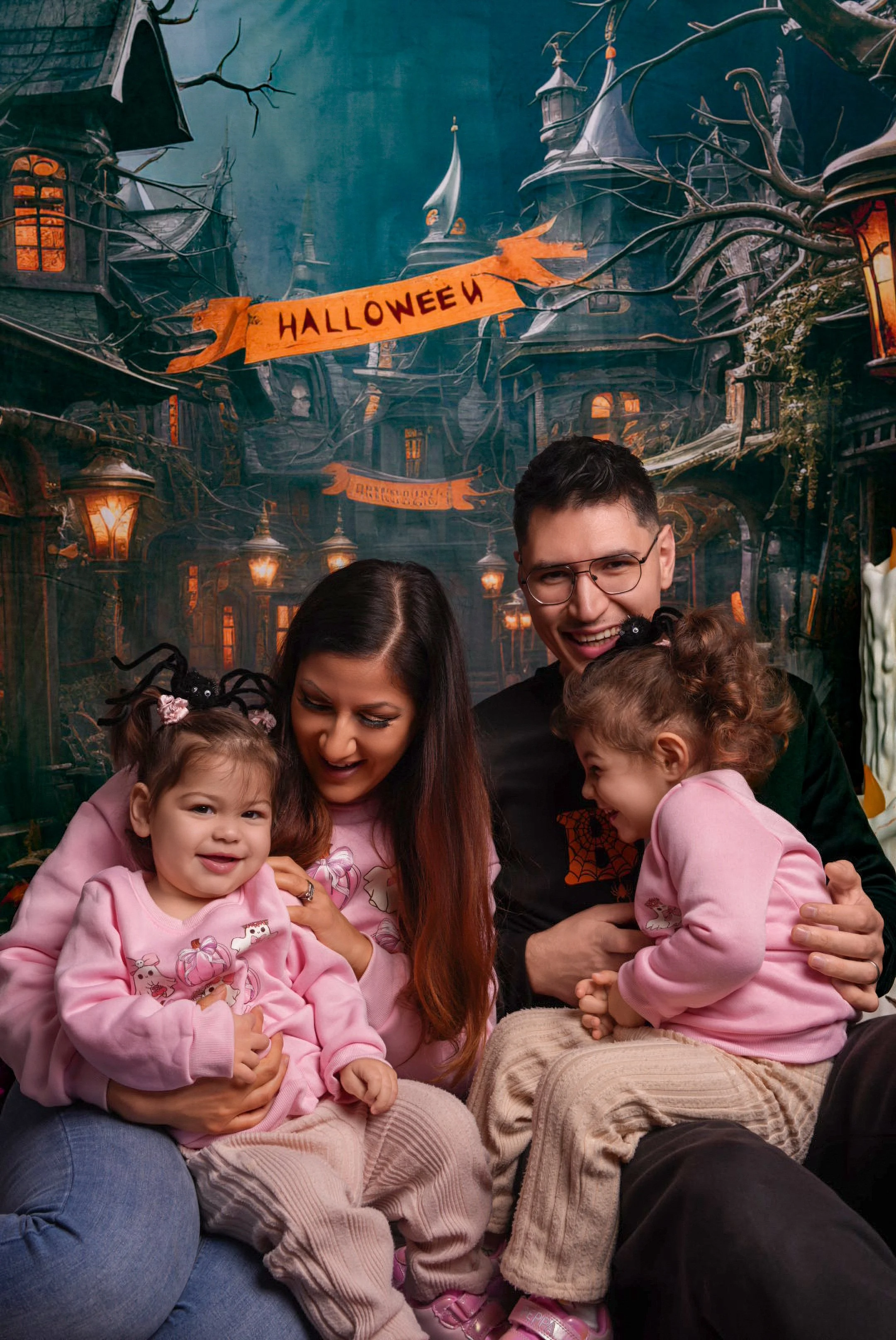 a-family-sitting-on-a-couch-in-front-of-a-halloween-house.jpg