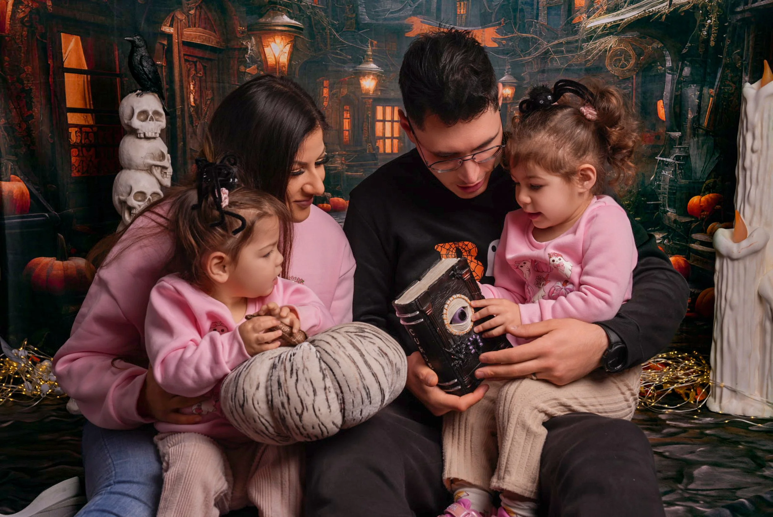 a-family-sitting-on-a-bed-with-a-book.jpg
