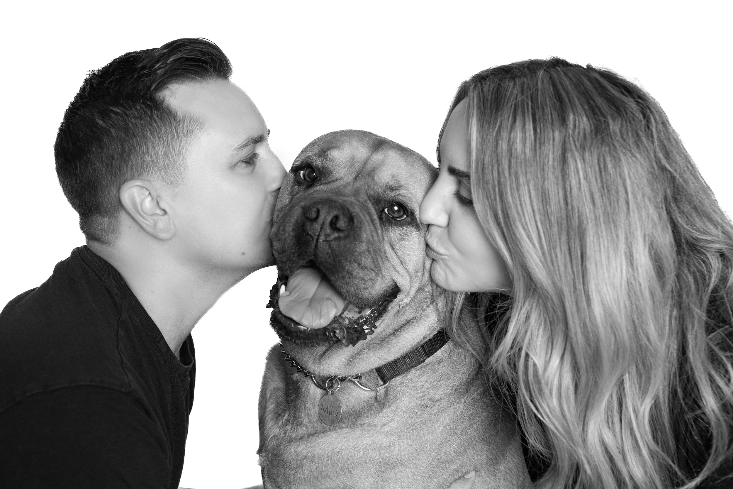 Relaxed family portrait outdoors with parents and children laughing naturally