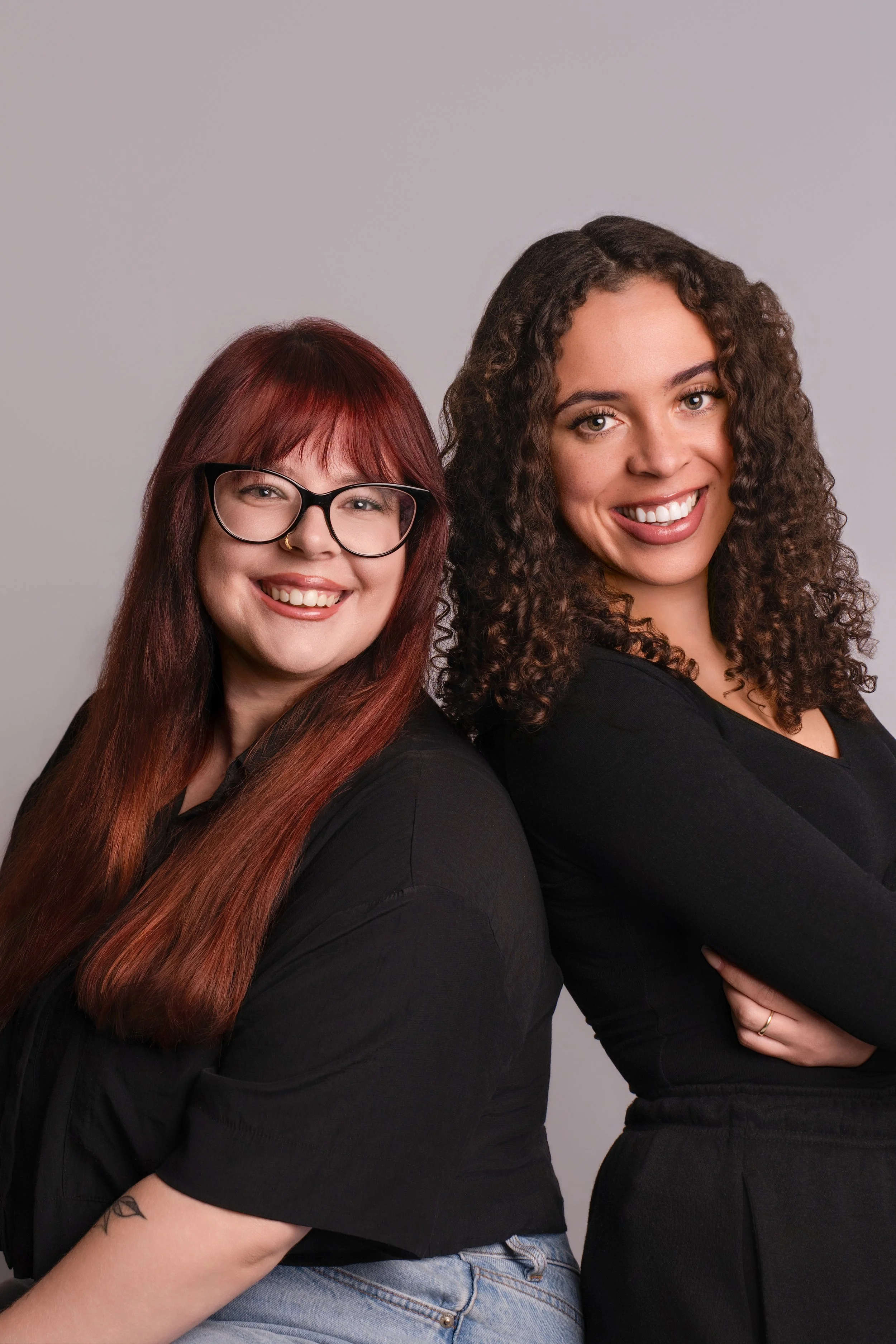 Professional headshot of creative business owner with natural light background