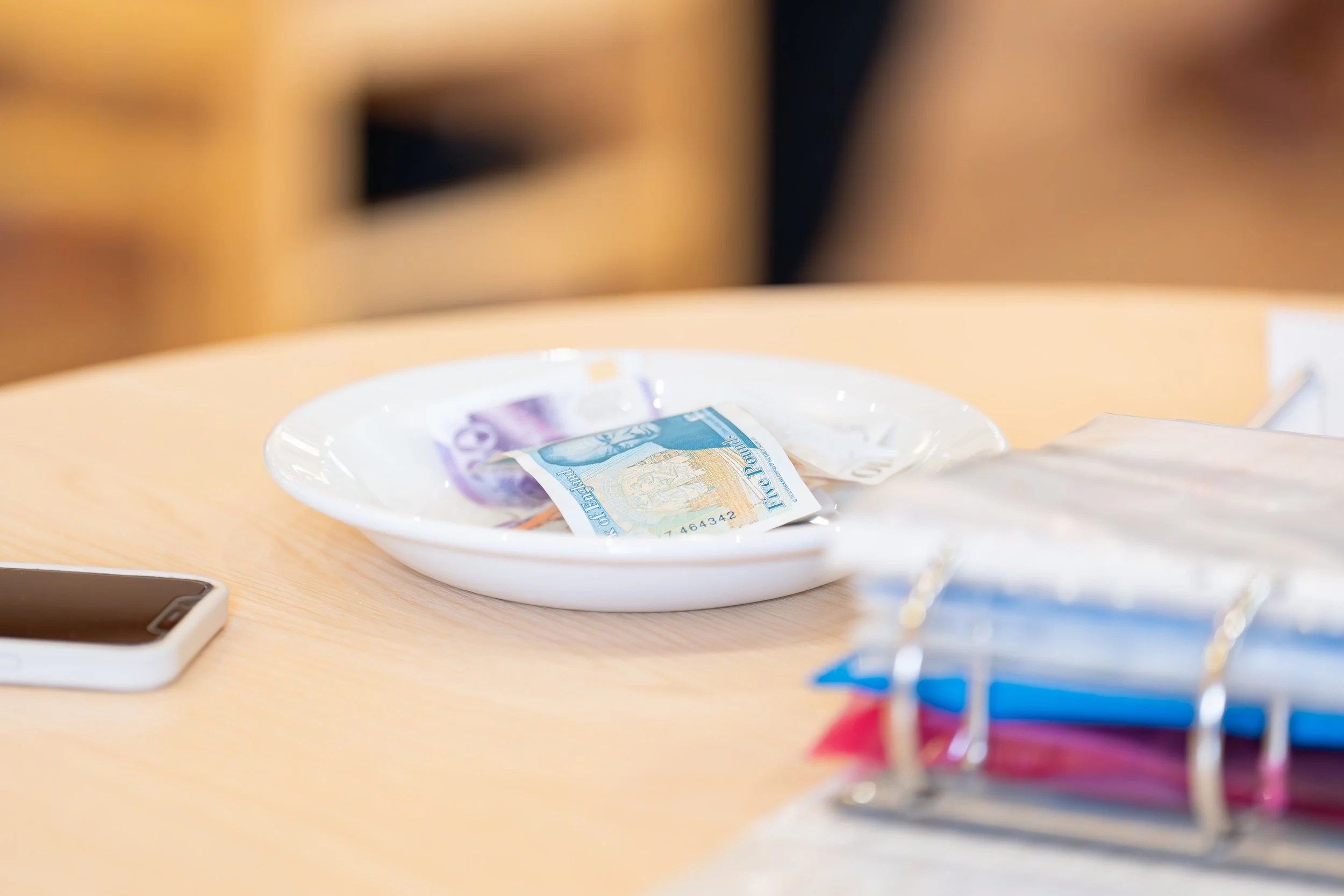 £5 ona plate with other notes a donation plate
