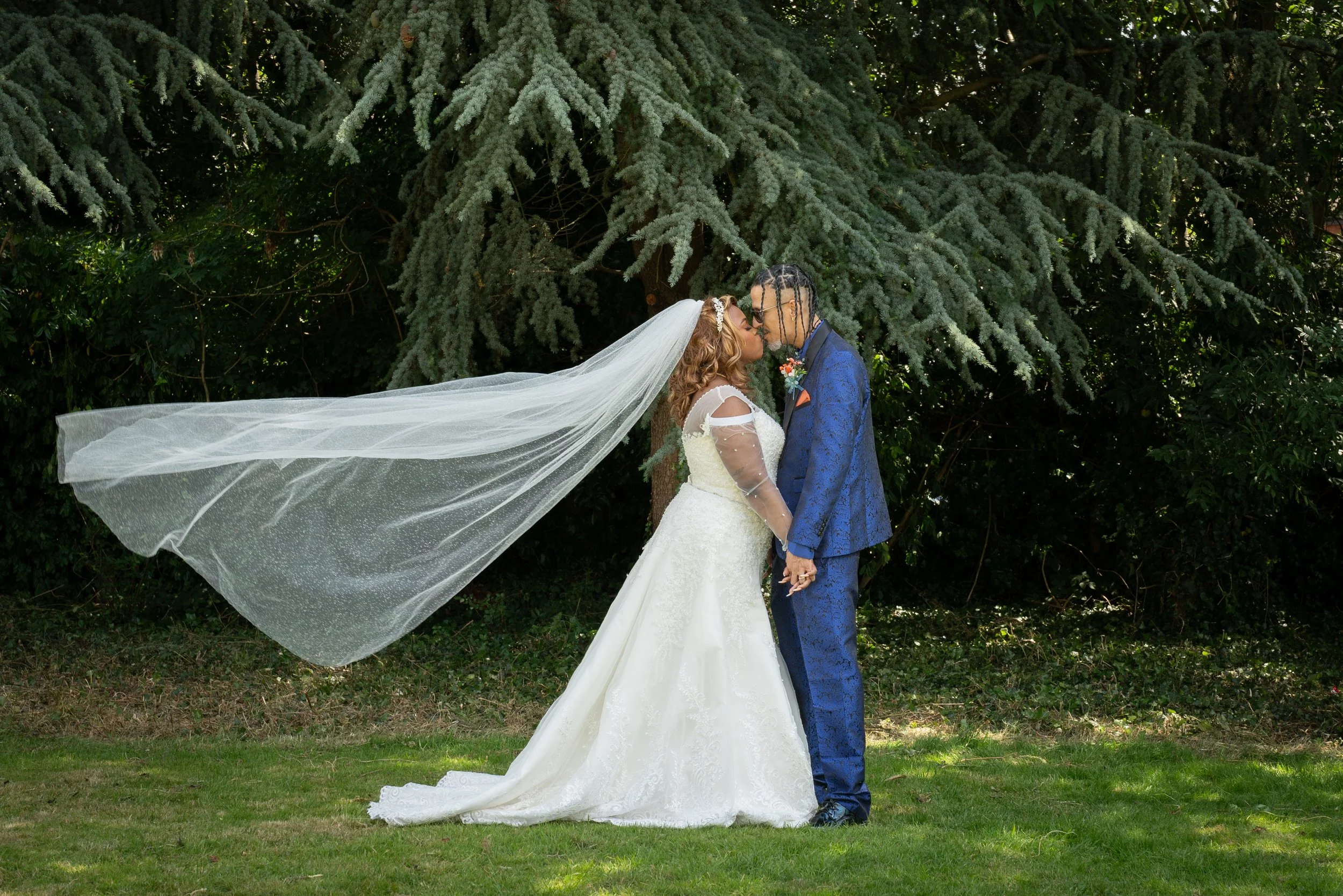 a-bride-and-groom-kissing-under-a-veil-2.jpg