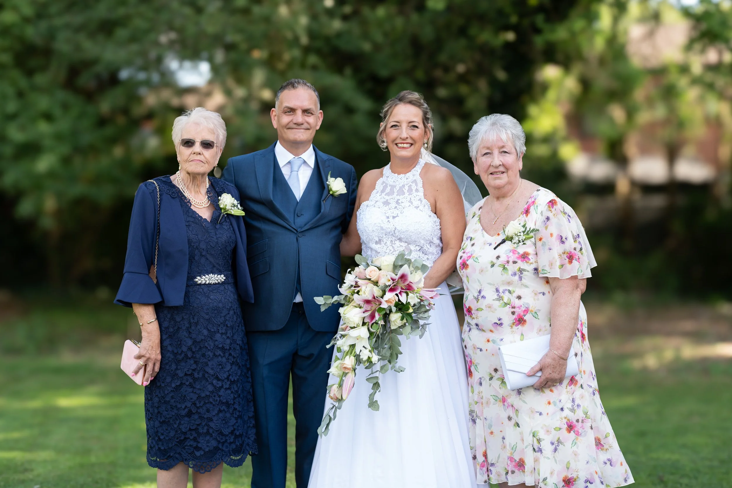 a-bride-and-her-family-pose-for-a-photo.jpg