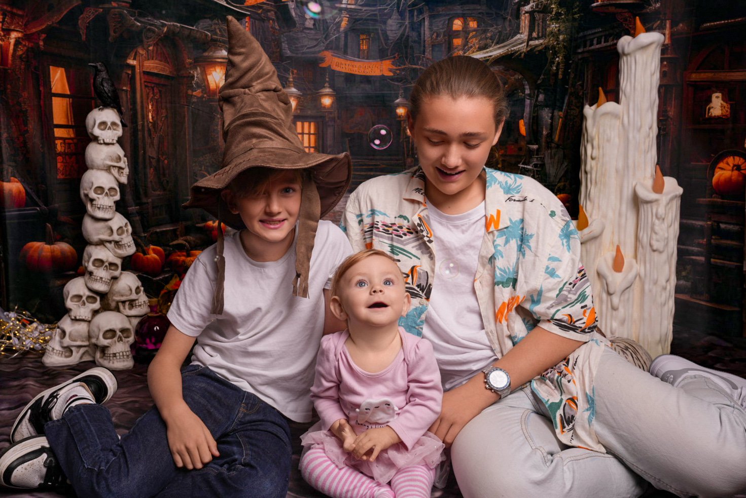 a-woman-and-two-children-sitting-on-a-bed.jpg