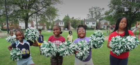 Four children standing outdoors with three holding large white and green flower arrangements.