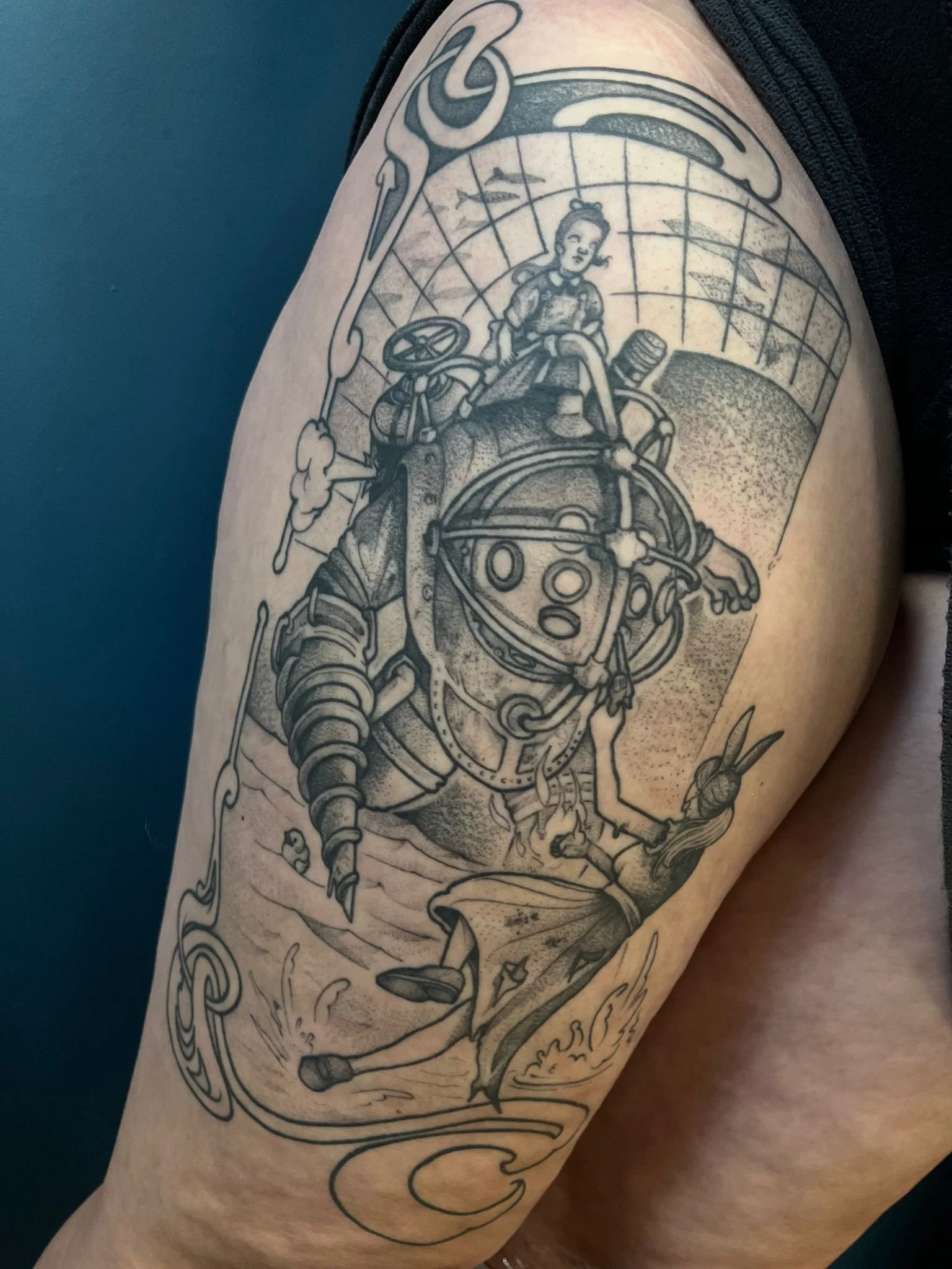 Tattoo of a person in a diving suit with a helmet, holding a device, on a woman's shoulder with a small girl sitting on top of the helmet, based on Bioshock, vivid and detailed black ink line art.