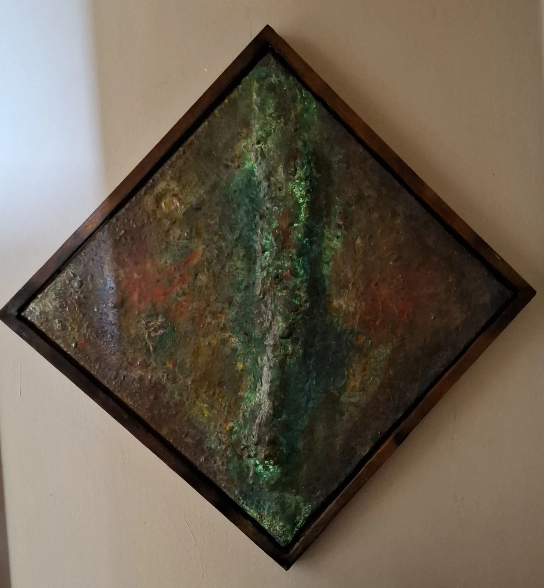 Ein diagonales Bild eines aquarienähnlichen Aquariums mit bunten Korallen und Wasserpflanzen, eingerahmt in dunklem Holz, an einer hellen Wand.