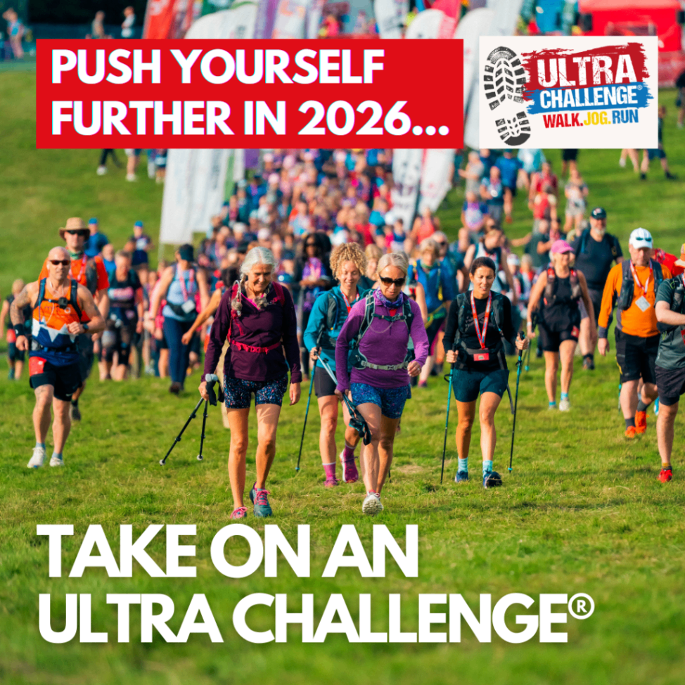 Large group of participants walking across countryside fields during an Ultra Challenge charity event