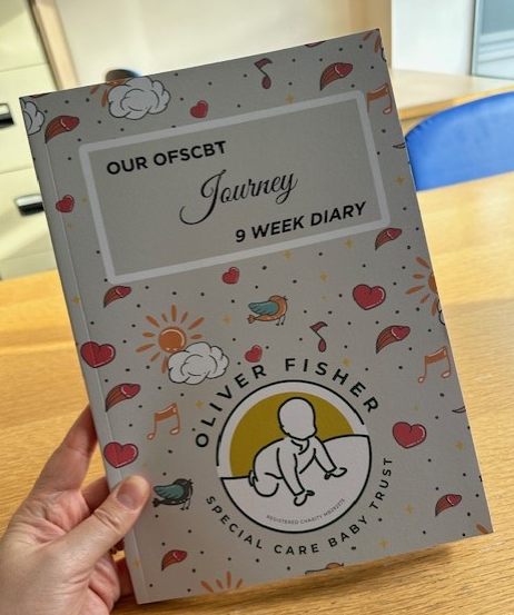 Person holding NICU journal booklet designed to help families record their baby’s journey and milestones